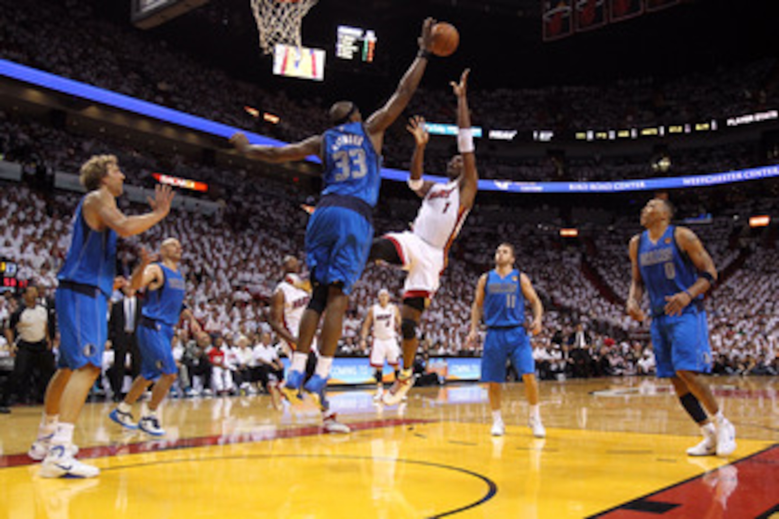 MIAMI, FL - MAY 31:  Chris Bosh #1 of the Miami Heat shoots over Brendan Haywood #33 of the Dallas Mavericks in the second half in Game One of the 2011 NBA Finals at American Airlines Arena on May 31, 2011 in Miami, Florida. NOTE TO USER: User expressly a