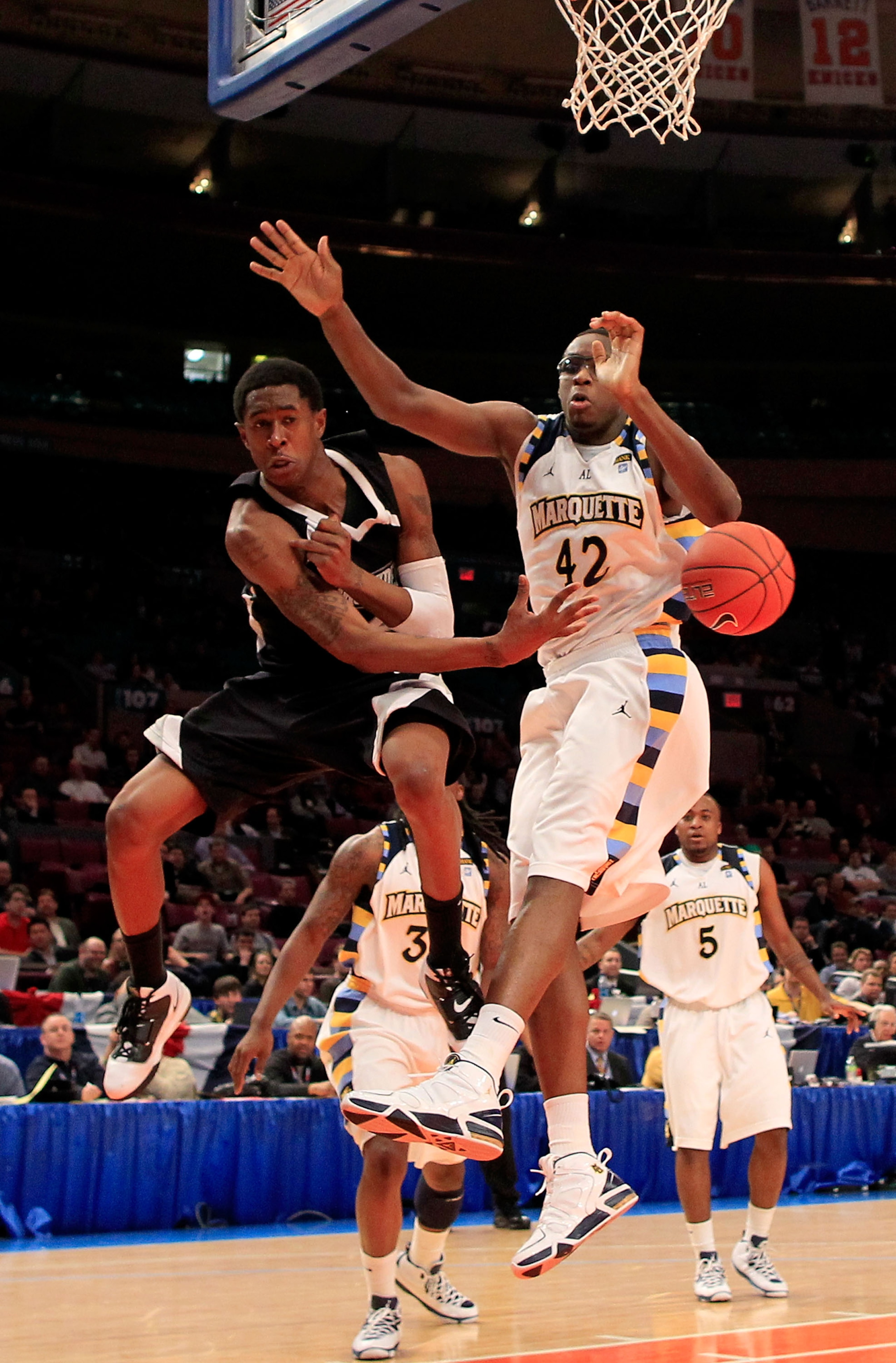 NEW YORK, NY - MARCH 08: Marshon Brooks #2 of the Providence Friars passes the ball against Chris Otule #42 of the Marquette Golden Eagles during the first round of the 2011 Big East Men's Basketball Tournament presented by American Eagle Outfitters at Ma