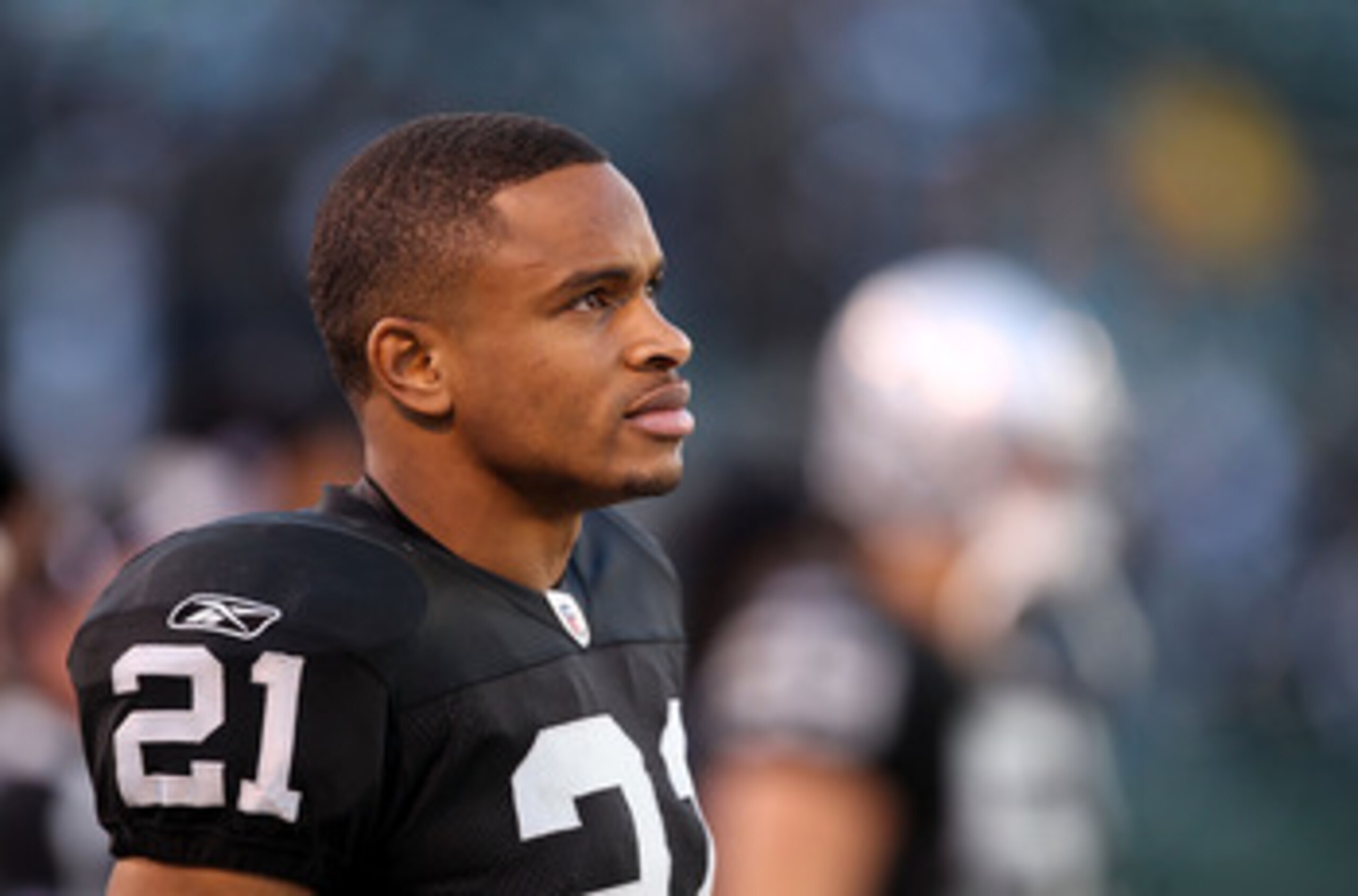 OAKLAND, CA - NOVEMBER 28:  Nnamdi Asomugha #21 of the Oakland Raiders stands on the sidelines during the closing minutes of their loss to the Miami Dolphins at Oakland-Alameda County Coliseum on November 28, 2010 in Oakland, California.  (Photo by Ezra S