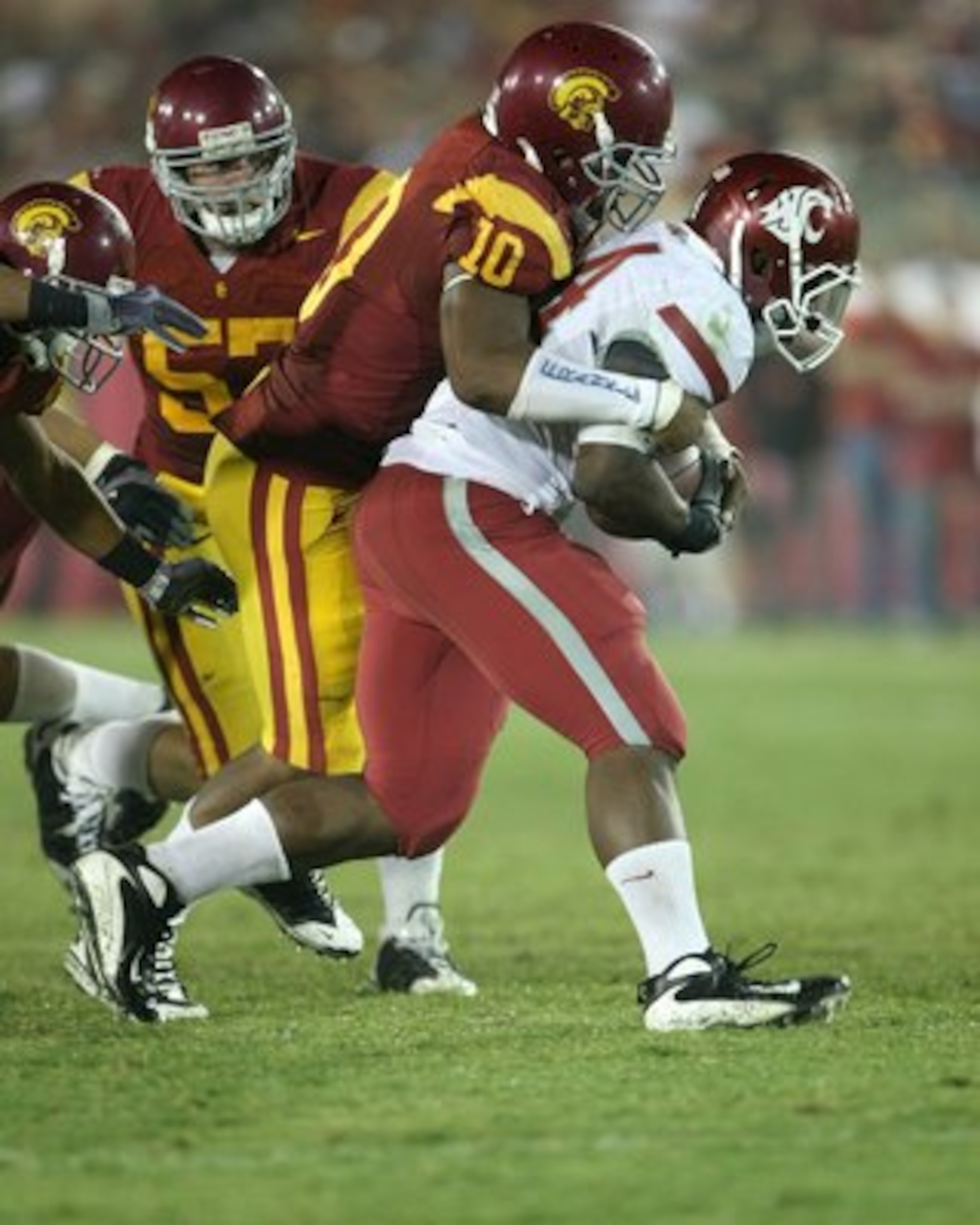 LOS ANGELES, CA - SEPTEMBER 26:  Linebacker Jarvis Jones #10 of the USC Trojans tackles running back Logwone Mitz #34 of the Washington State Cougars on September 23, 2009 at the Los Angeles Coliseum in Los Angeles, California.  USC won 27-6.  (Photo by S