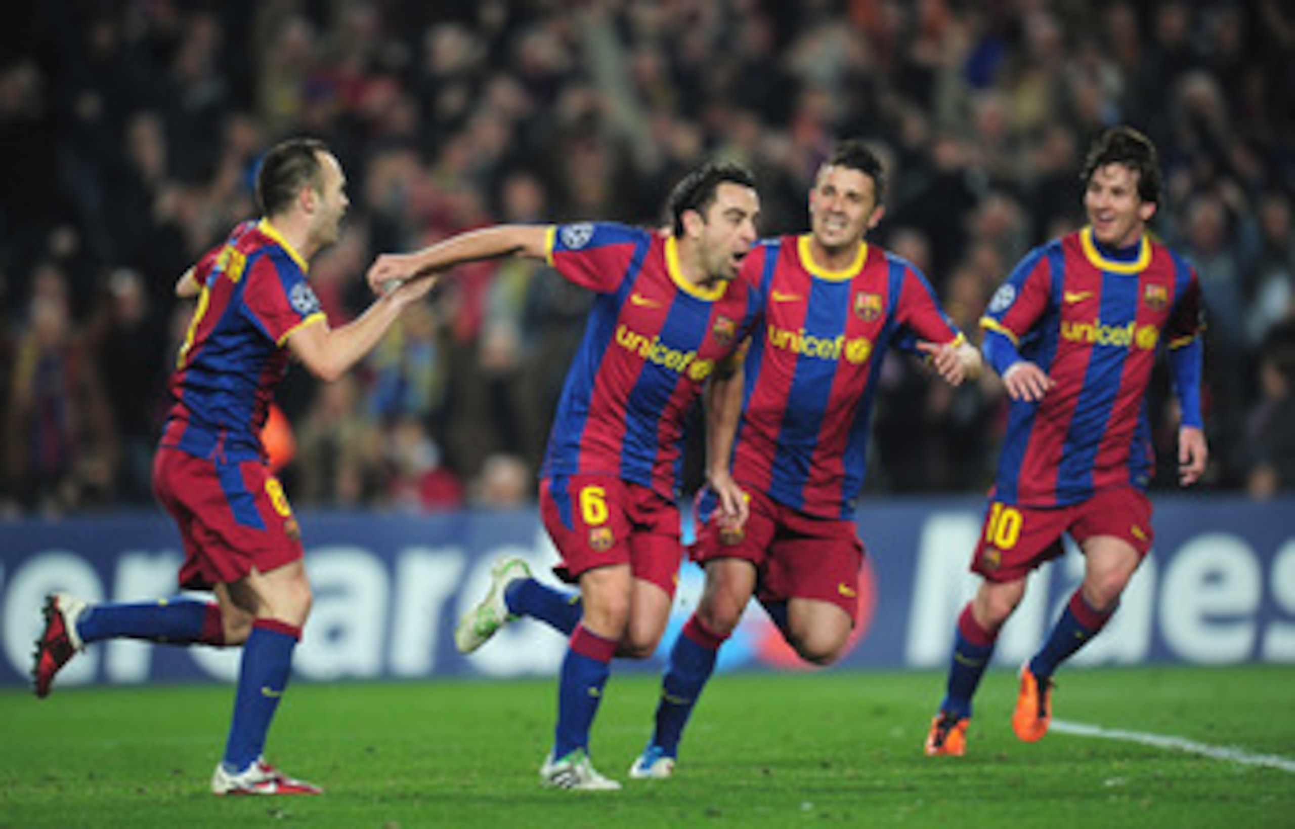 BARCELONA, SPAIN - MARCH 08: Xavi Hernandez of Barcelona celebrates with team-mates David Villa and Andres Iniesta during the UEFA Champions League round of 16 second leg match between Barcelona and Arsenal at the Nou Camp Stadium on March 8, 2011 in Bar BARCELONA, SPAIN - MARCH 08: Xavi Hernandez of Barcelona celebrates with team-mates David Villa and Andres Iniesta during the UEFA Champions League round of 16 second leg match between Barcelona and Arsenal at the Nou Camp Stadium on March 8, 2011 in Bar