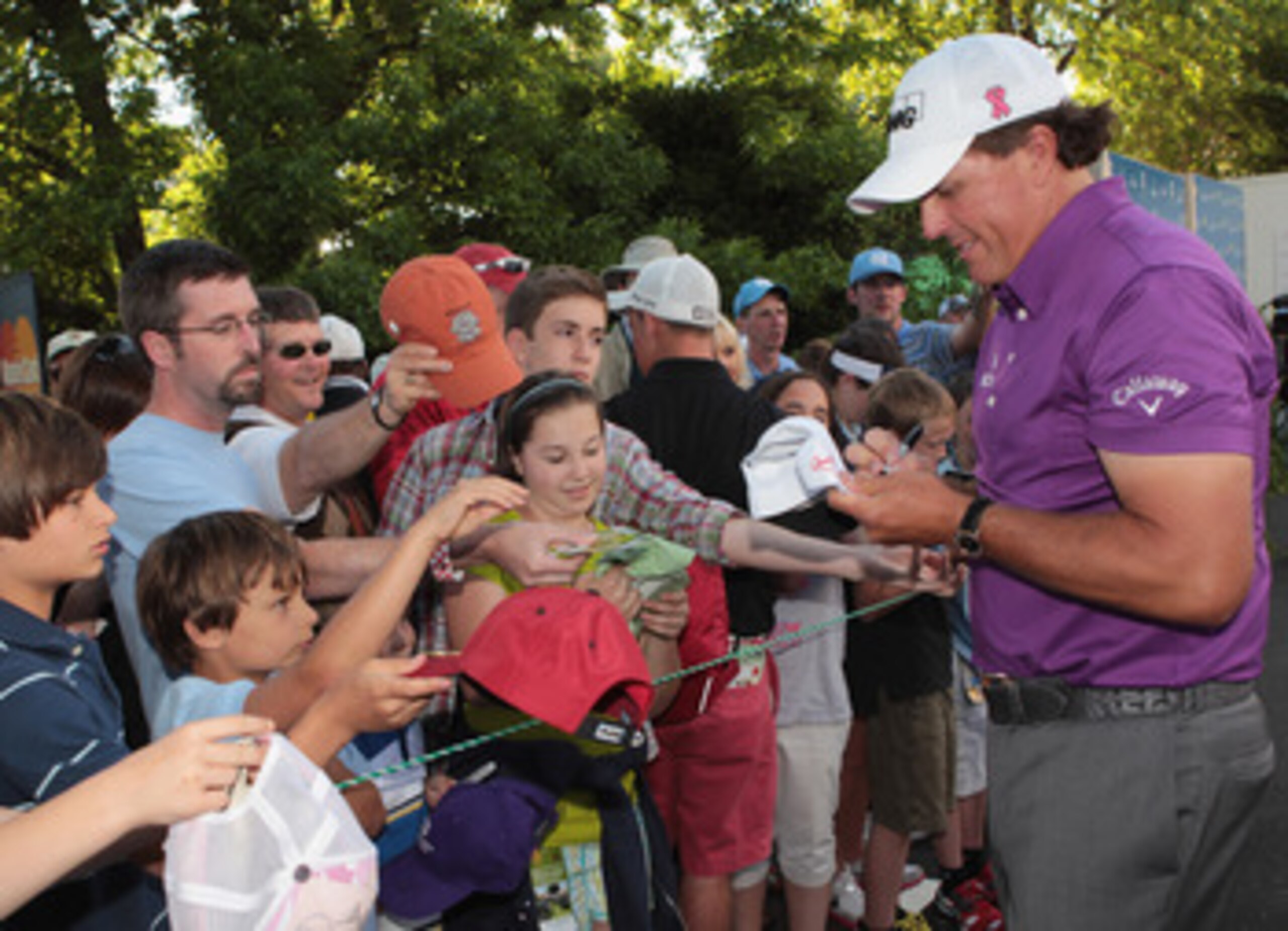CHARLOTTE, NC - MAY 05:  Phil Mickelson signs autographs for fans during the first round of the Wells Fargo Championship at the Quail Hollow Club on May 5, 2011 in Charlotte, North Carolina.  (Photo by Scott Halleran/Getty Images)