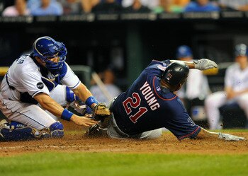 KANSAS CITY, MO - JUNE 2:  Delmon Young #21 of the Minnesota Twins slides in ahead of the tag of Matt Treanor #15 of the Kansas City Royals at Kauffman Stadium on June 2, 2011 in Kansas City, Missouri. (Photo by G. Newman Lowrance/Getty Images)