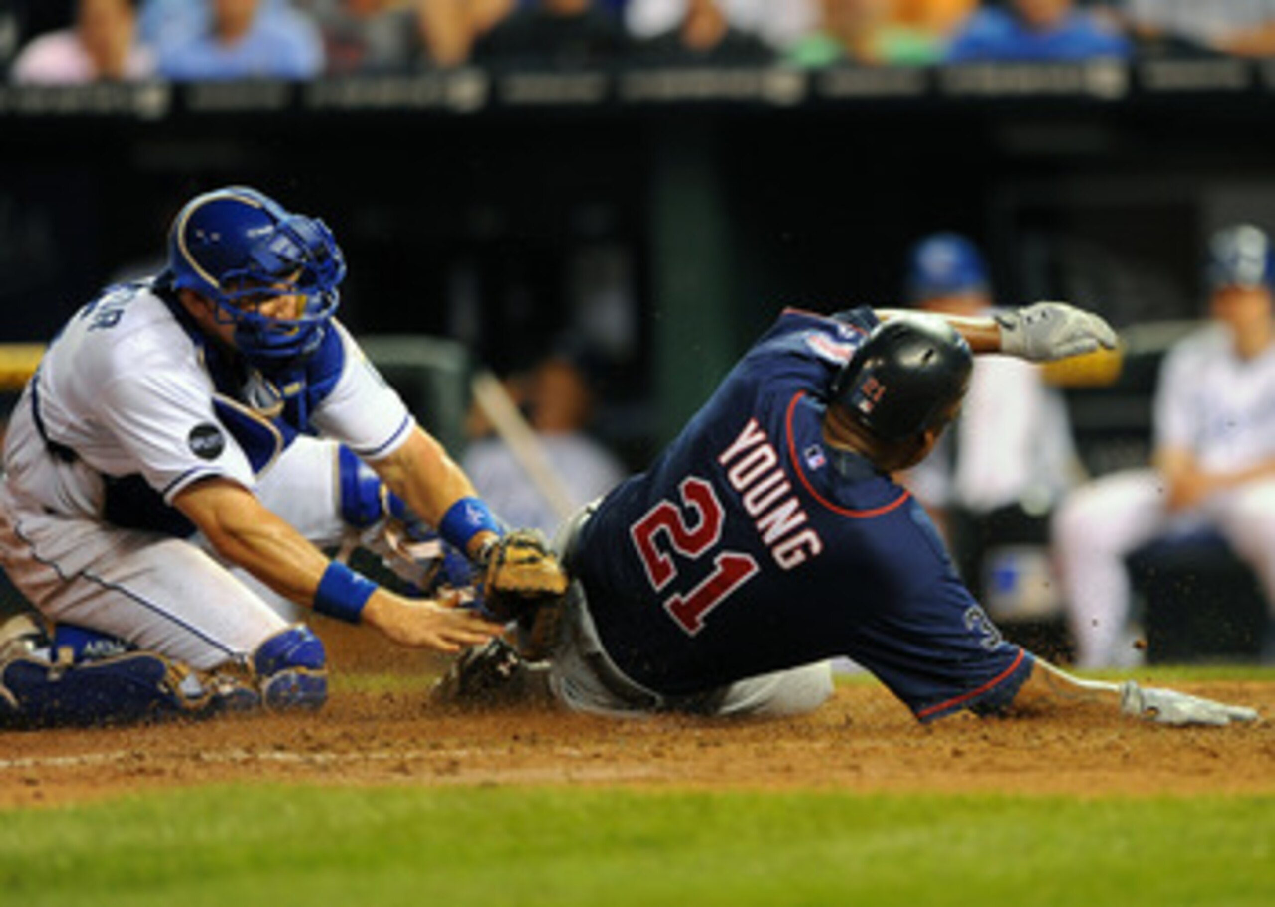 KANSAS CITY, MO - JUNE 2:  Delmon Young #21 of the Minnesota Twins slides in ahead of the tag of Matt Treanor #15 of the Kansas City Royals at Kauffman Stadium on June 2, 2011 in Kansas City, Missouri. (Photo by G. Newman Lowrance/Getty Images)