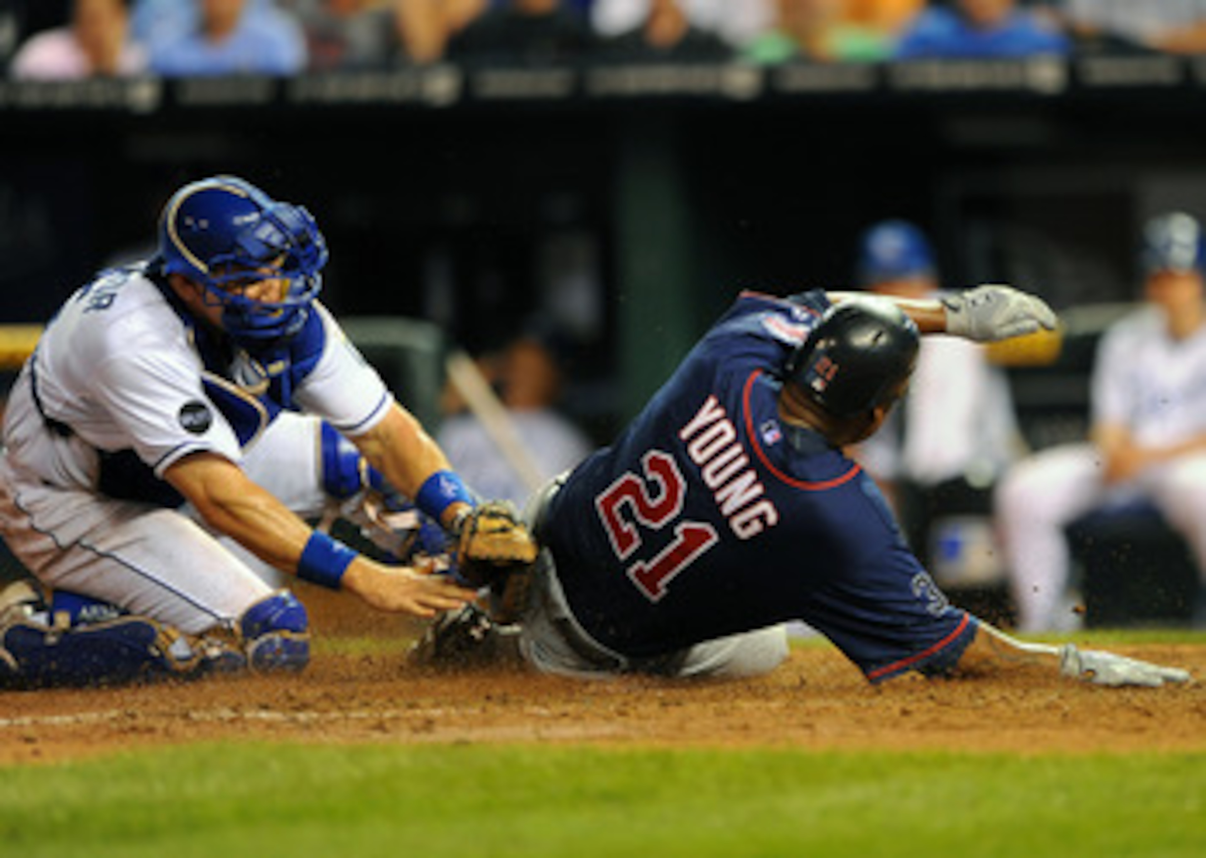 KANSAS CITY, MO - JUNE 2:  Delmon Young #21 of the Minnesota Twins slides in ahead of the tag of Matt Treanor #15 of the Kansas City Royals at Kauffman Stadium on June 2, 2011 in Kansas City, Missouri. (Photo by G. Newman Lowrance/Getty Images)