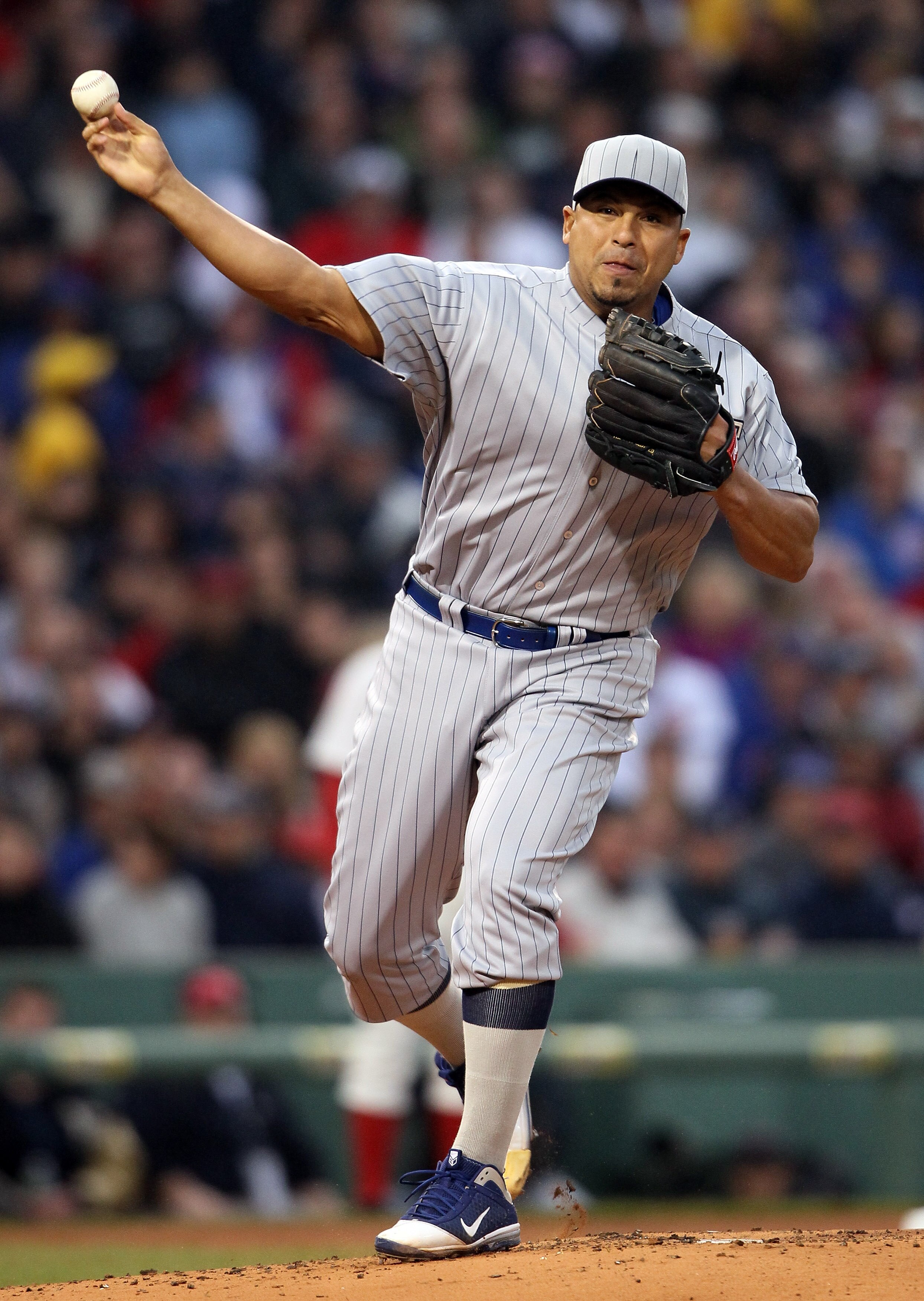 BOSTON, MA - MAY 21:  Carlos Zambrano #38 of the Chicago Cubs sends the ball back to first base in the first inning against the Boston Red Sox on May 21, 2011 at Fenway Park in Boston, Massachusetts. Tonight the Chicago Cubs and the Boston Red Sox are wea