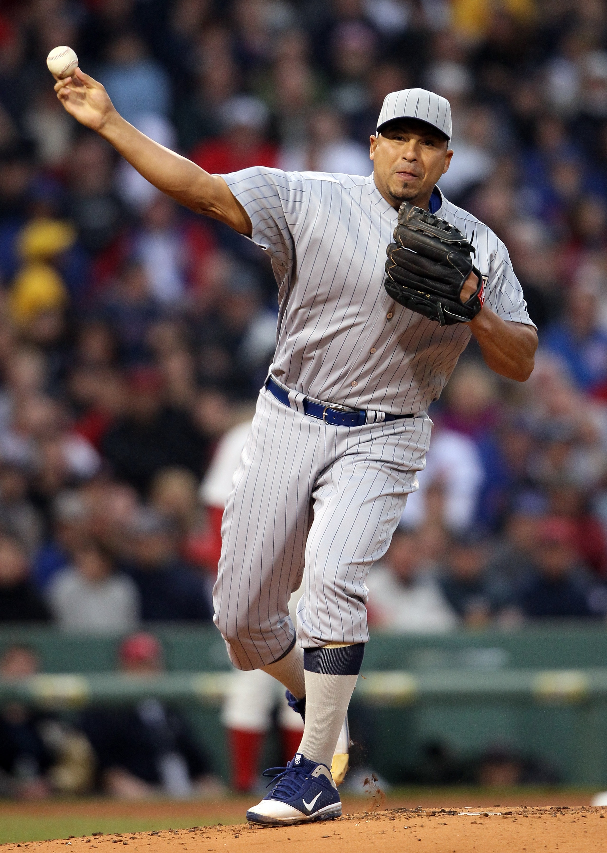 BOSTON, MA - MAY 21:  Carlos Zambrano #38 of the Chicago Cubs sends the ball back to first base in the first inning against the Boston Red Sox on May 21, 2011 at Fenway Park in Boston, Massachusetts. Tonight the Chicago Cubs and the Boston Red Sox are wea