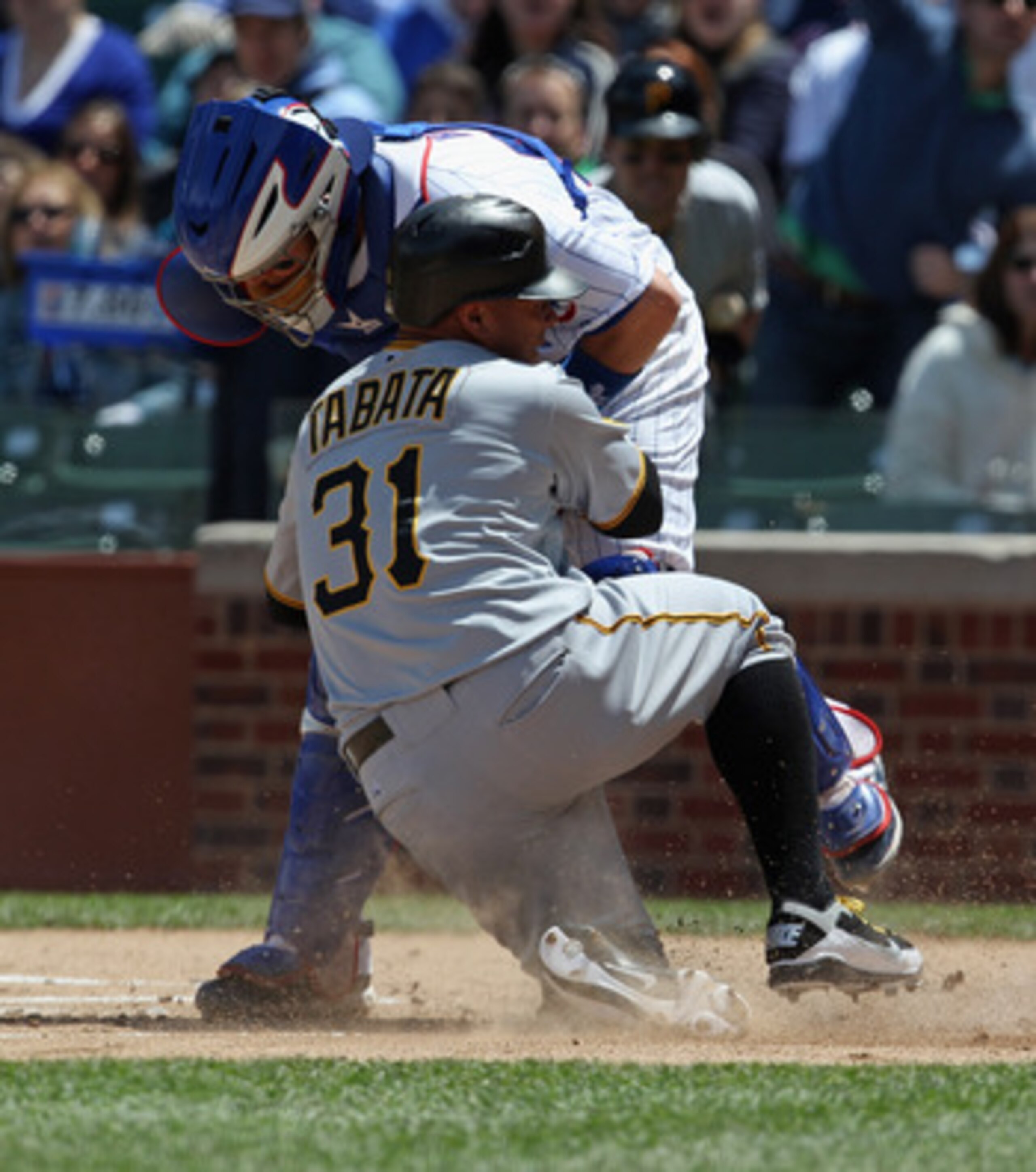CHICAGO, IL - MAY 27: Jose Tabata #31 of the Pittsburgh Pirates is out as he collides at home plate with Koyie Hill #55 of the Chicago Cubsat Wrigley Field on May 27, 2011 in Chicago, Illinois. (Photo by Jonathan Daniel/Getty Images)