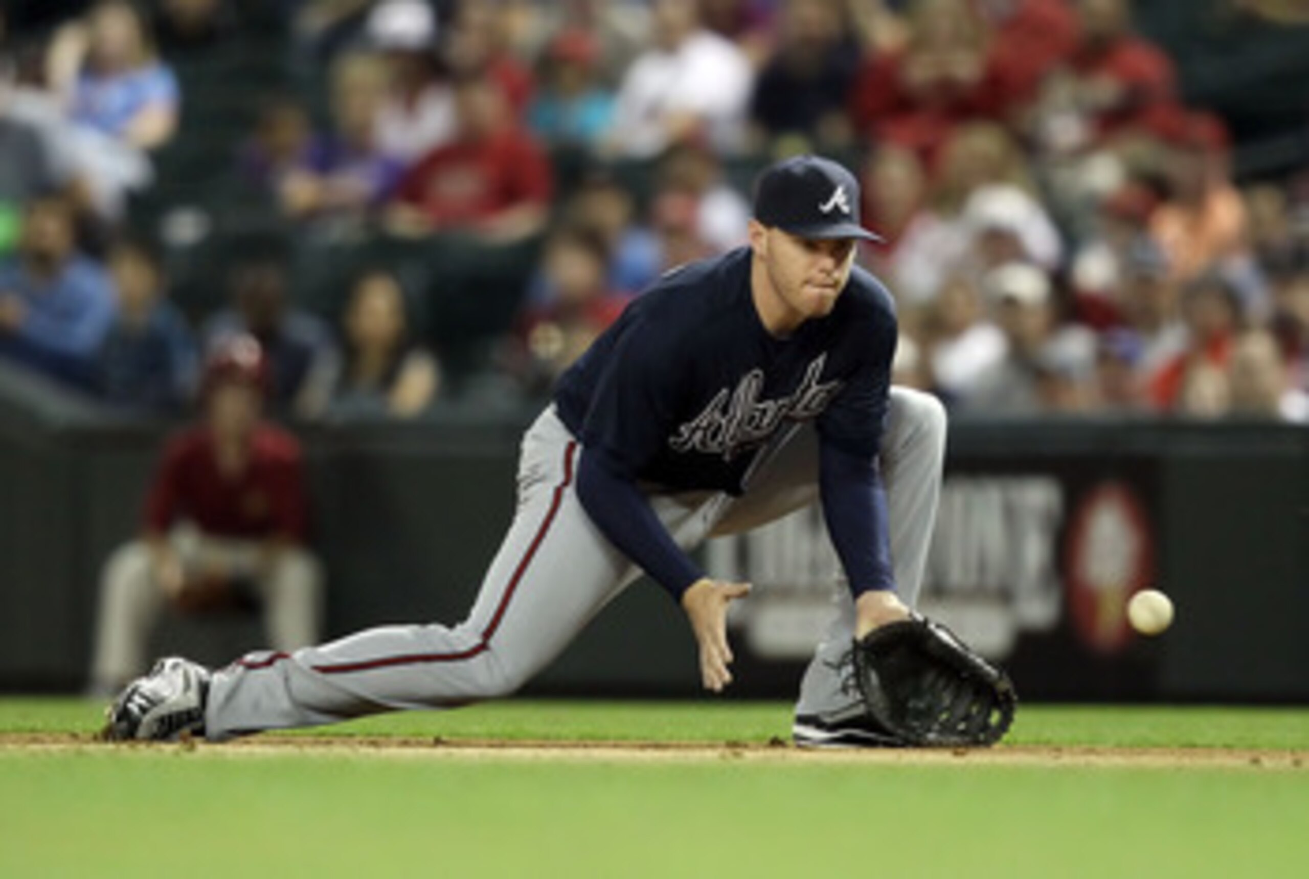 PHOENIX, AZ - MAY 18:  Infielder Freddie Freeman #5 of the Atlanta Braves fields a ground ball out against the Arizona Diamondbacks during the Major League Baseball game at Chase Field on May 18, 2011 in Phoenix, Arizona.  (Photo by Christian Petersen/Get