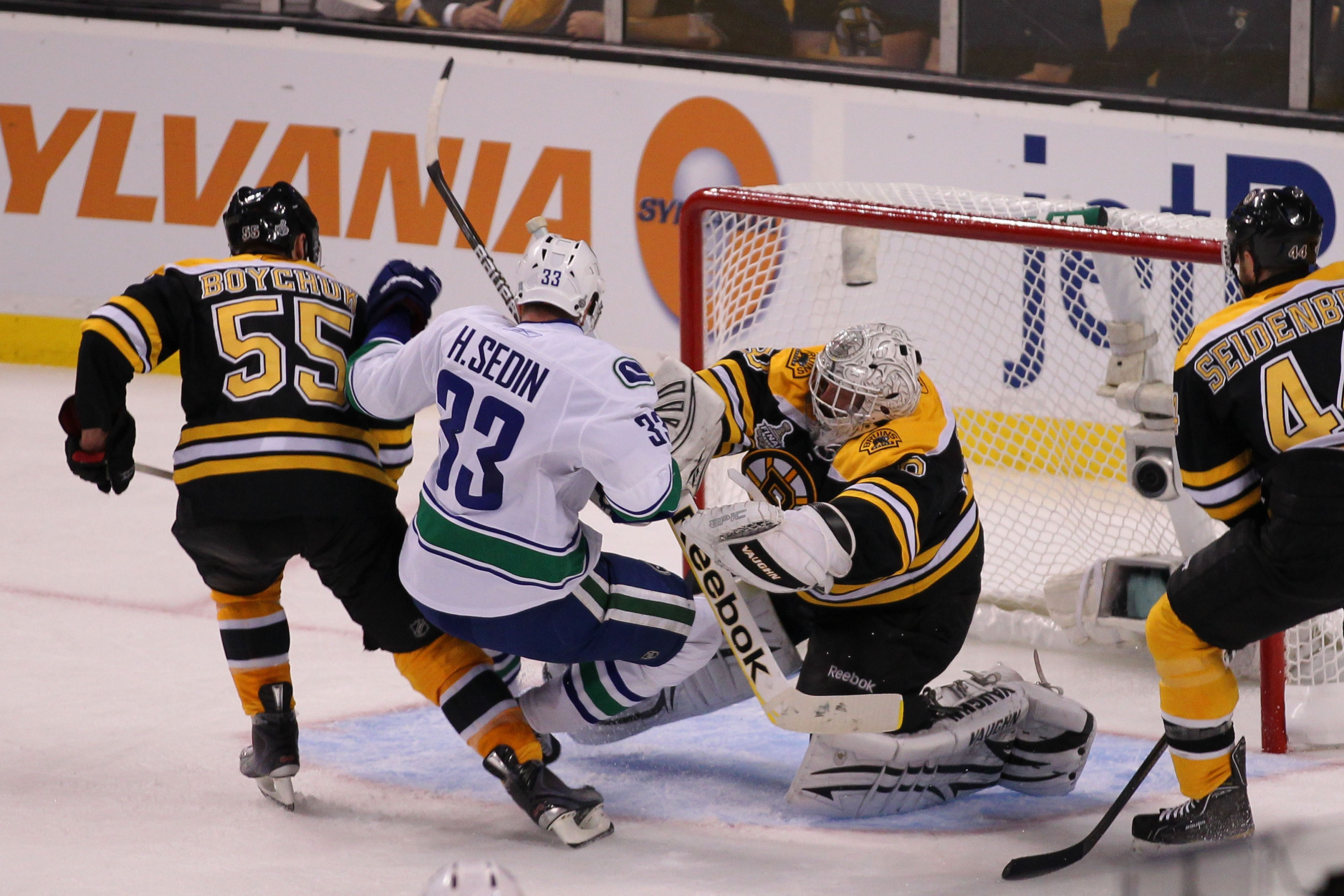 BOSTON, MA - JUNE 06:  Tim Thomas #30 of the Boston Bruins checks Henrik Sedin #33 of the Vancouver Canucks as he tends goal during Game Three of the 2011 NHL Stanley Cup Final at TD Garden on June 6, 2011 in Boston, Massachusetts.  (Photo by Jim Rogash/G