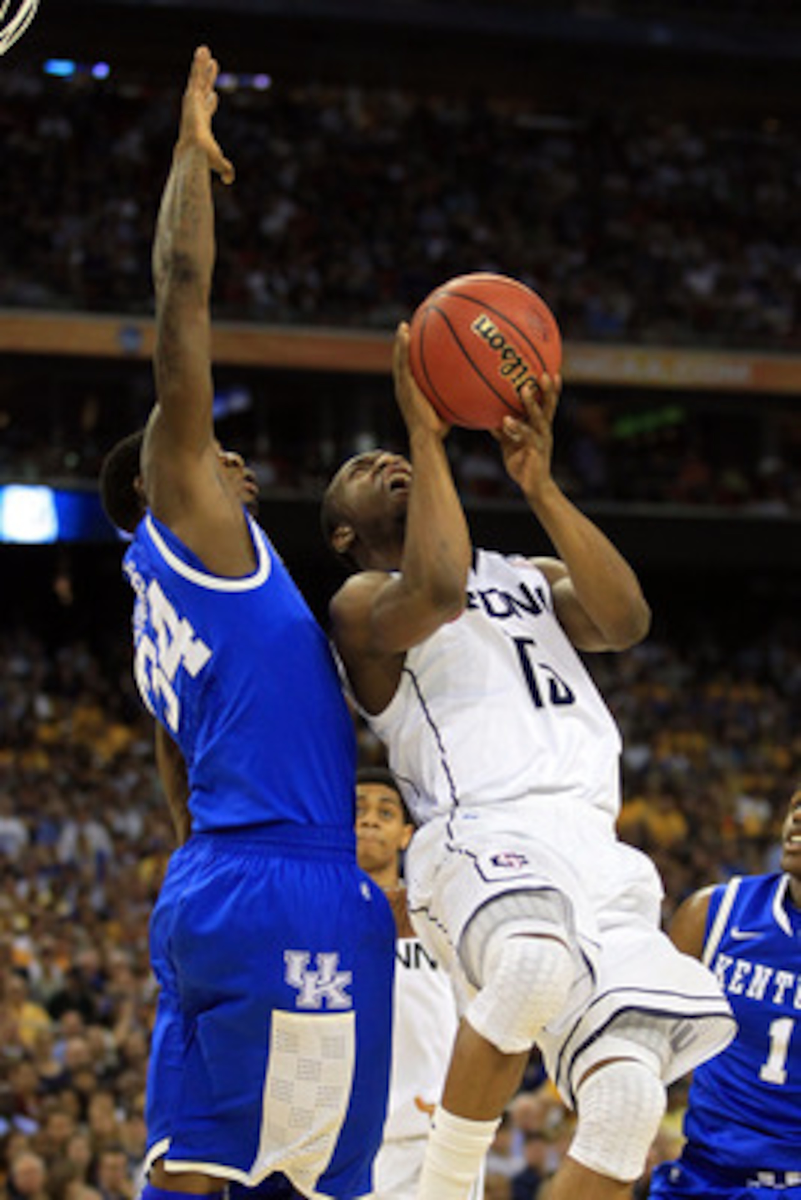 HOUSTON, TX - APRIL 02:  Kemba Walker #15 of the Connecticut Huskies goes up for a shoot against DeAndre Liggins #34 of the Kentucky Wildcats during the National Semifinal game of the 2011 NCAA Division I Men's Basketball Championship at Reliant Stadium o