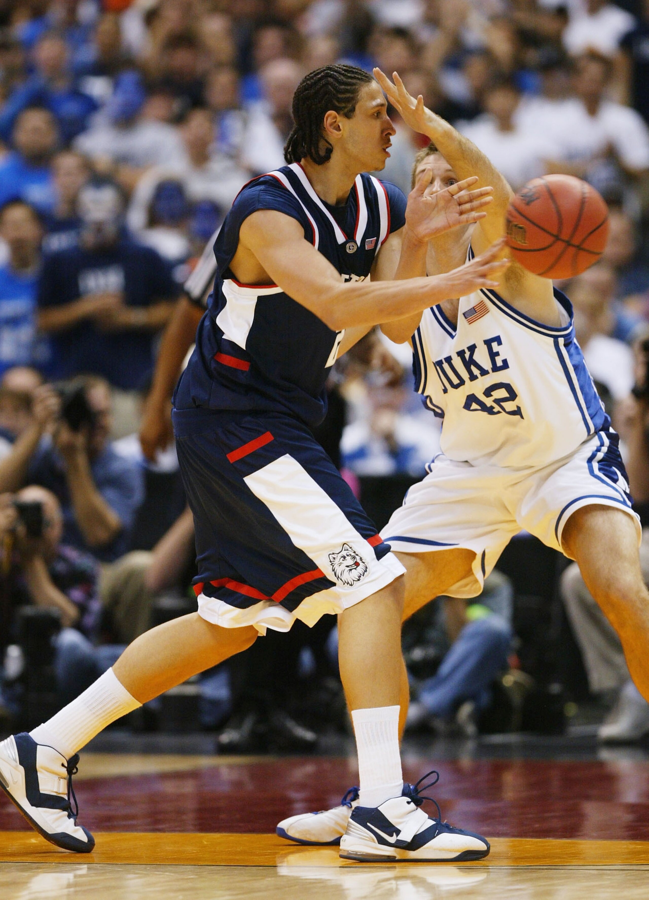 SAN ANTONIO - APRIL 3:  Josh Boone #21 of the UConn Huskies is guarded by Shavlik Randolph #42 of the Duke Blue Devils during the semifinal game of the NCAA Final Four Tournament at the Alamodome on April 3, 2004 in San Antonio, Texas.  (Photo by Doug Pen