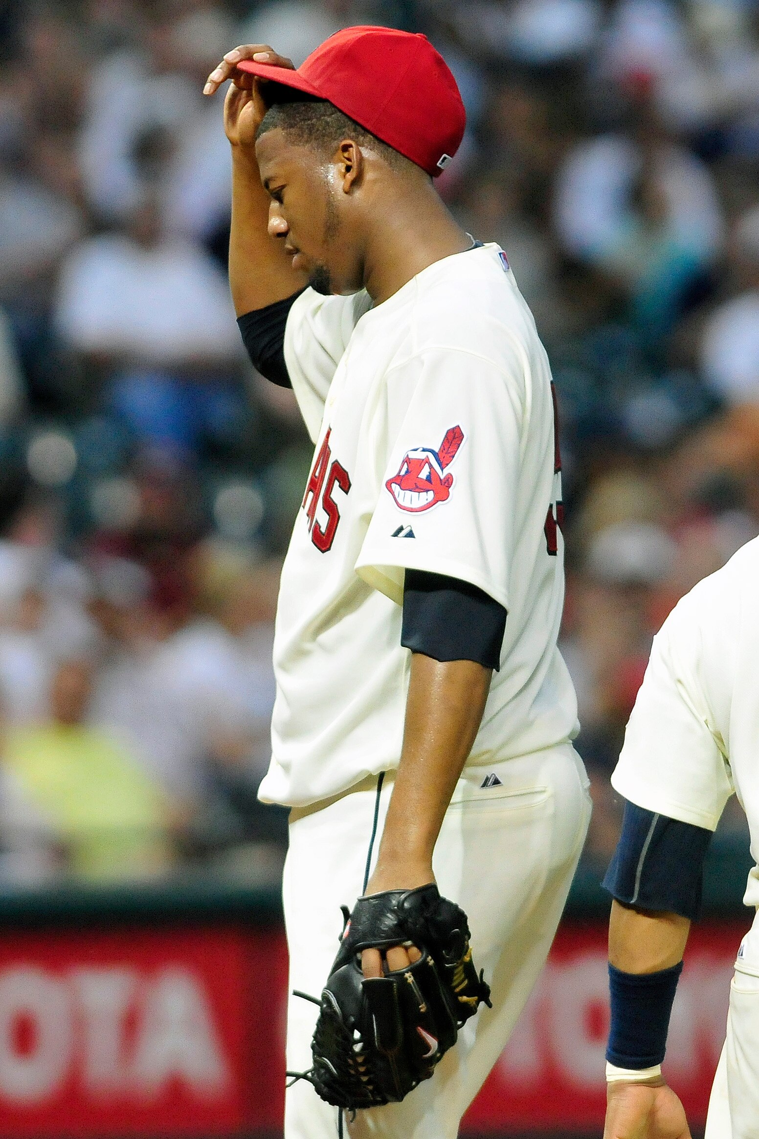 CLEVELAND, OH - JUNE 4: Fausto Carmona #55 of the Cleveland Indians reacts after giving up a two run home run during the seventh inning against the Texas Rangers at Progressive Field on June 4, 2011 in Cleveland, Ohio. The Rangers defeated the Indians 4-0