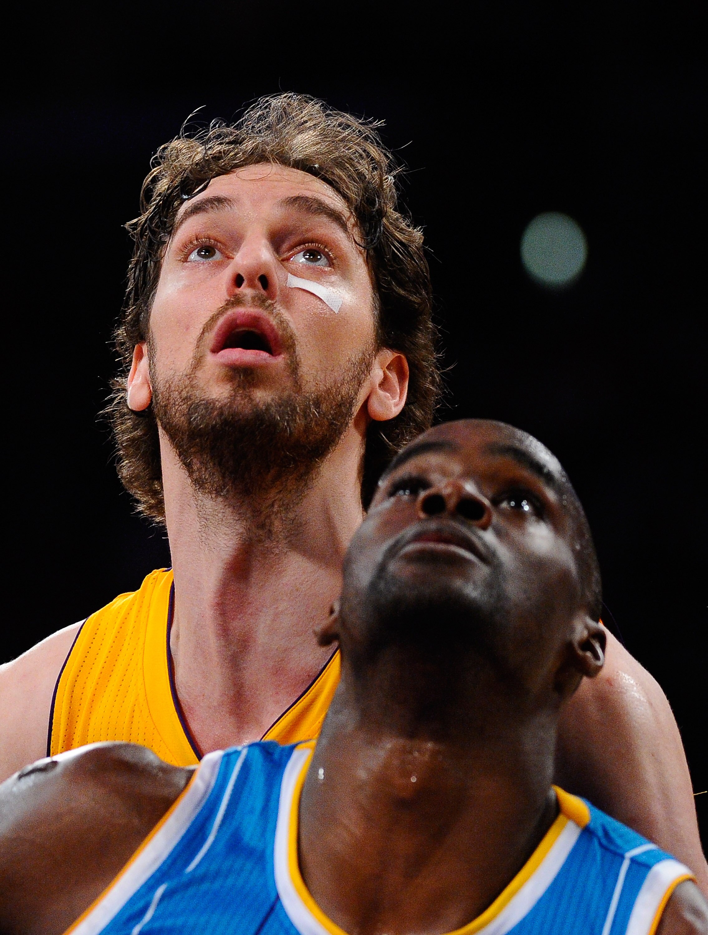 LOS ANGELES, CA - APRIL 20:  Pau Gasol #16 of the Los Angeles Lakers stands behind Emeka Okafor #50 of the New Orleans Hornets in Game Two of the Western Conference Quarterfinals in the 2011 NBA Playoffs on April 20, 2011 at Staples Center in Los Angeles,