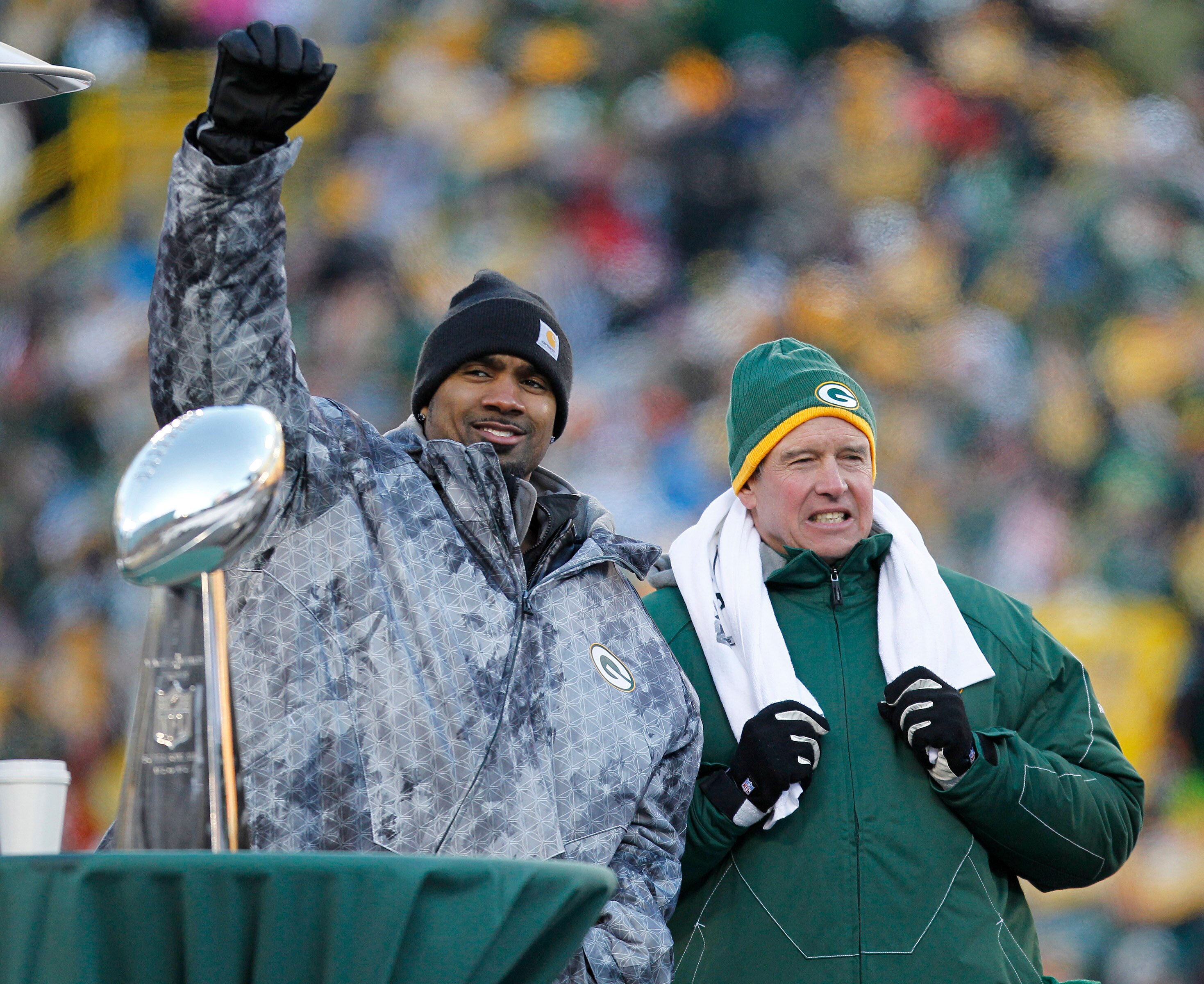 GREEN BAY, WI - FEBRUARY 08:  Green Bay Packers cornerback Charles Woodson and Defensive Coordinator Dom Capers take the stage to address the fans during the Packers victory celebration at Lambeau Field on February 8, 2011 in Green Bay, Wisconsin.  (Photo