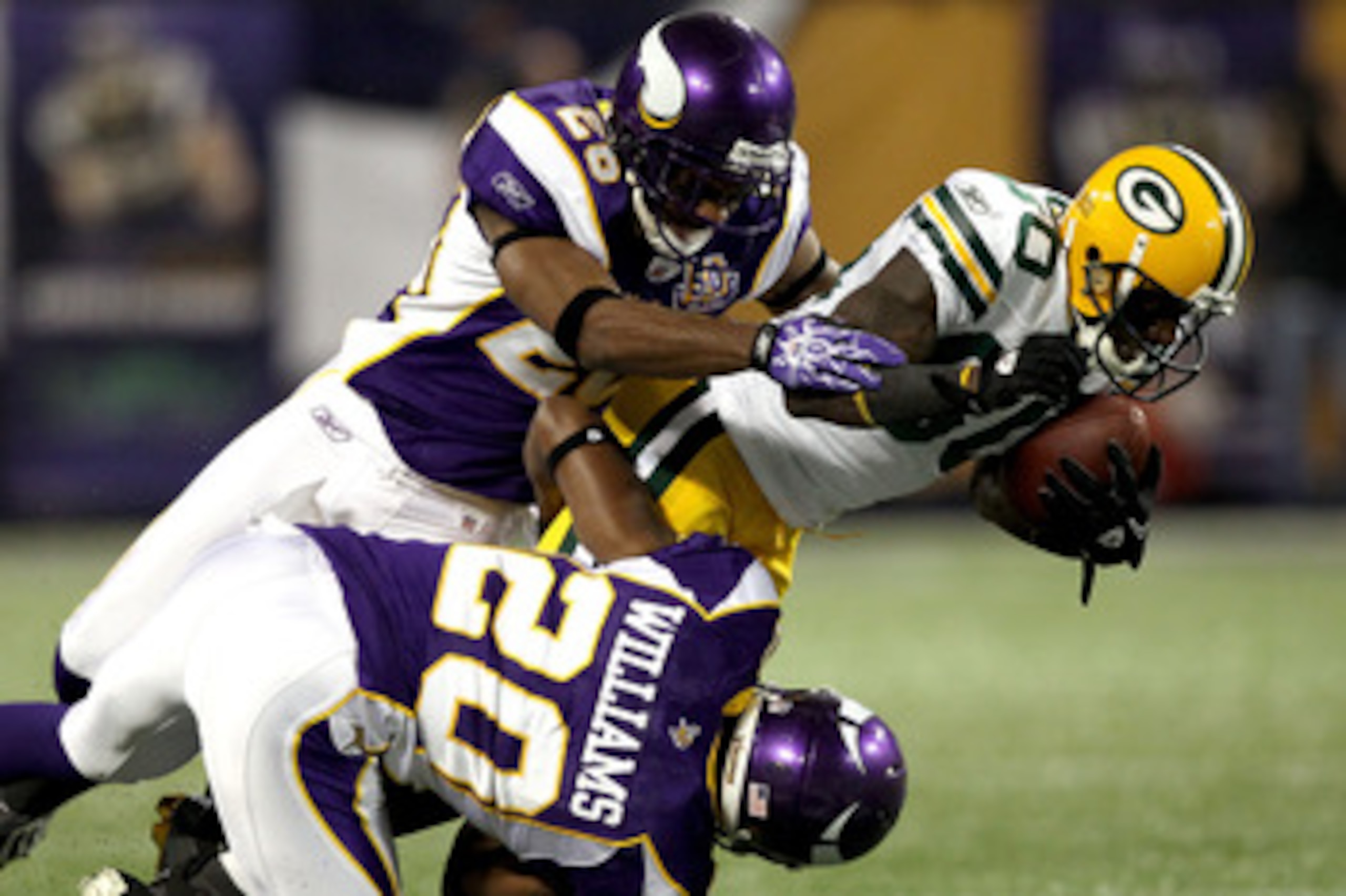 MINNEAPOLIS - NOVEMBER 21: Donald Driver #80 of the Green Bay Packers is brought down by Antonio Winfield #26 and Madieu Williams #20 of the Minnesota Vikings at the Hubert H. Humphrey Metrodome on November 21, 2010 in Minneapolis, Minnesota.  (Photo by M