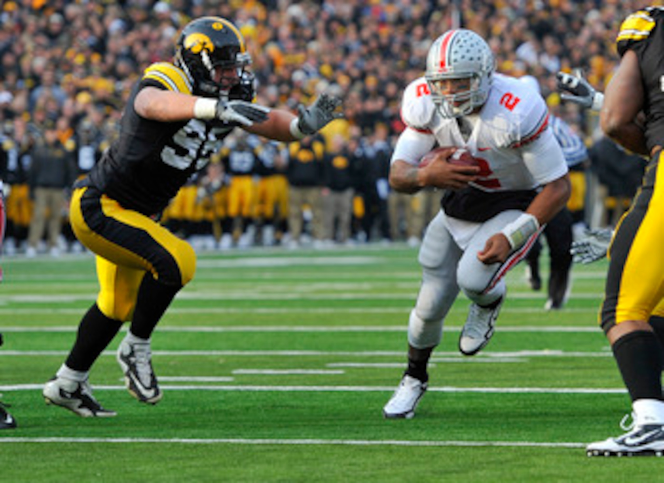 IOWA CITY, IA - NOVEMBER 20:  Defeisive lineman Karl Klug #95 of the University of Iowa Hawkeyes close in for the tackle on quarterback Terrelle Pryor #2 of the Ohio State Buckeyes as he drive the ball towards the goal line during the first half of play a