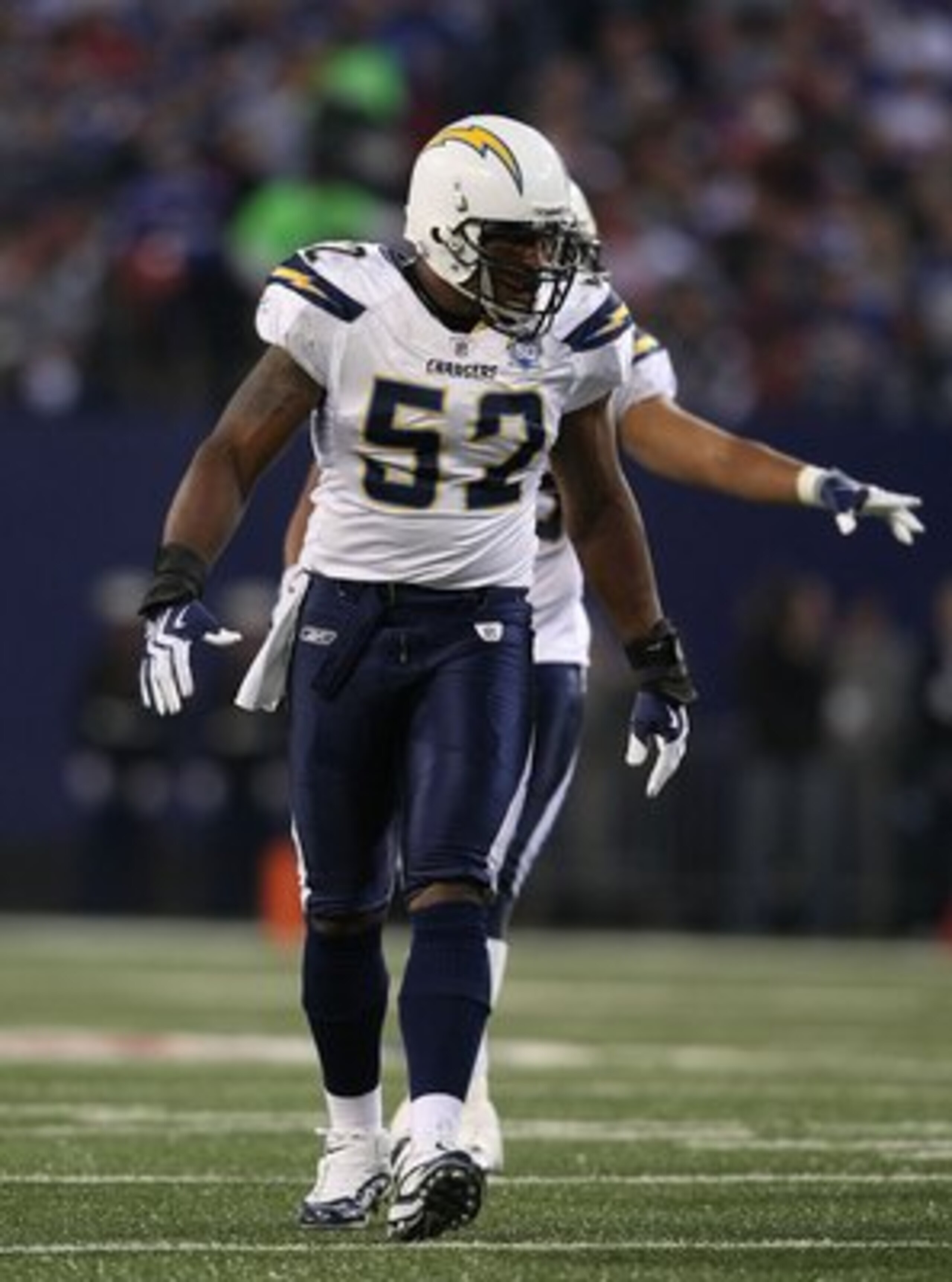 EAST RUTHERFORD, NJ - NOVEMBER 8:  Larry English #52 of the San Diego Chargers gestures against the New York Giants at Giants Stadium on November 8, 2009 in East Rutherford, New Jersey. The Chargers defeated the Giants 21-20.  (Photo by Nick Laham/Getty I
