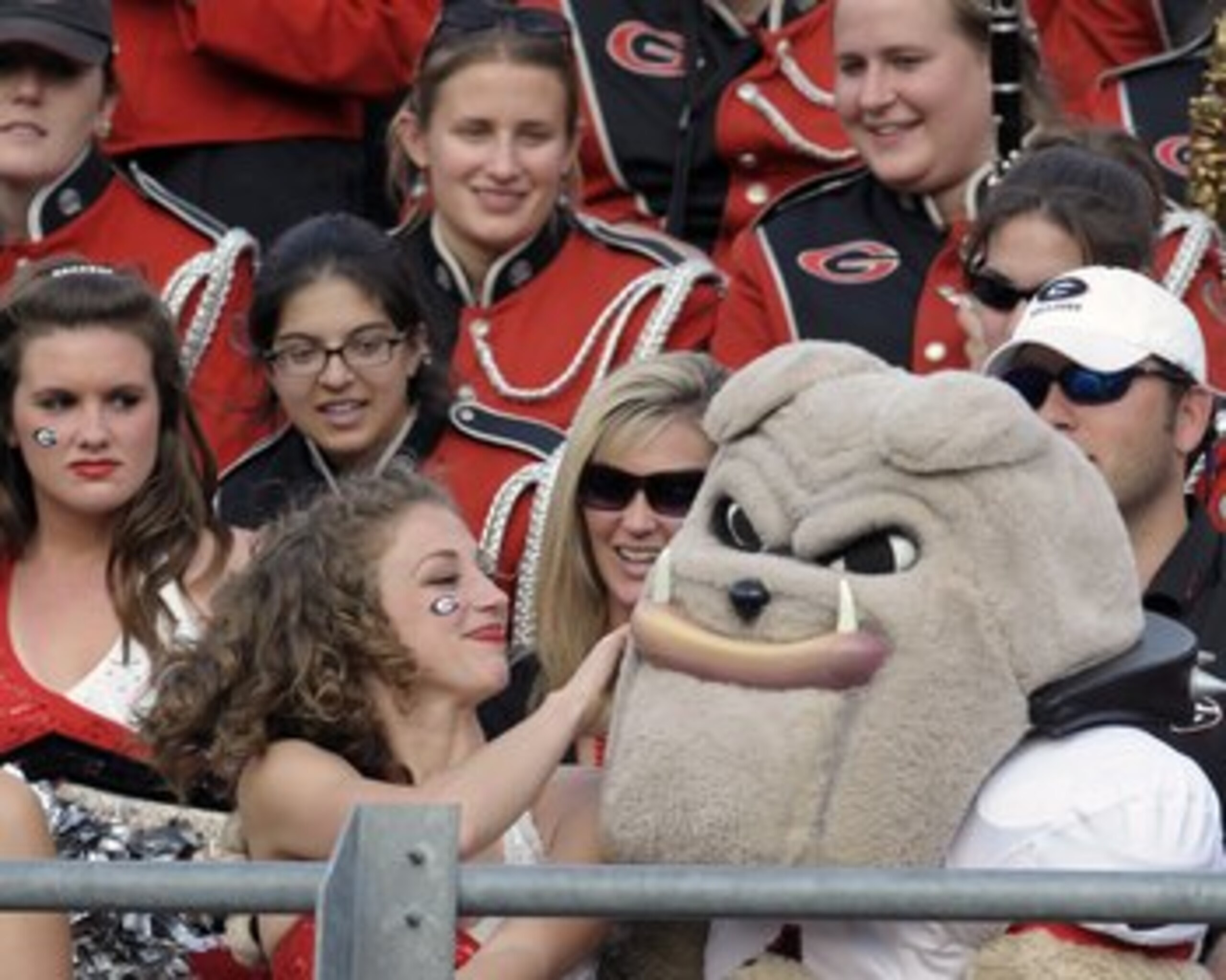 ORLANDO, FL - JANUARY 1: A cheerleader of the University of Georgia pets Hairy Dawg, the costumed team mascot during play against the Michigan State Spartans at the 2009 Capital One Bowl at the Citrus Bowl on January 1, 2009 in Orlando, Florida.  (Photo b