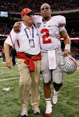 NEW ORLEANS, LA - JANUARY 04:  (M) Quarterback Terrelle Pryor #2 of the Ohio State Buckeyes is helped off the field by a member of the Buckeyes support team after the Buckeyes 31-26 victory against the Arkansas Razorbacks during the Allstate Sugar Bowl at
