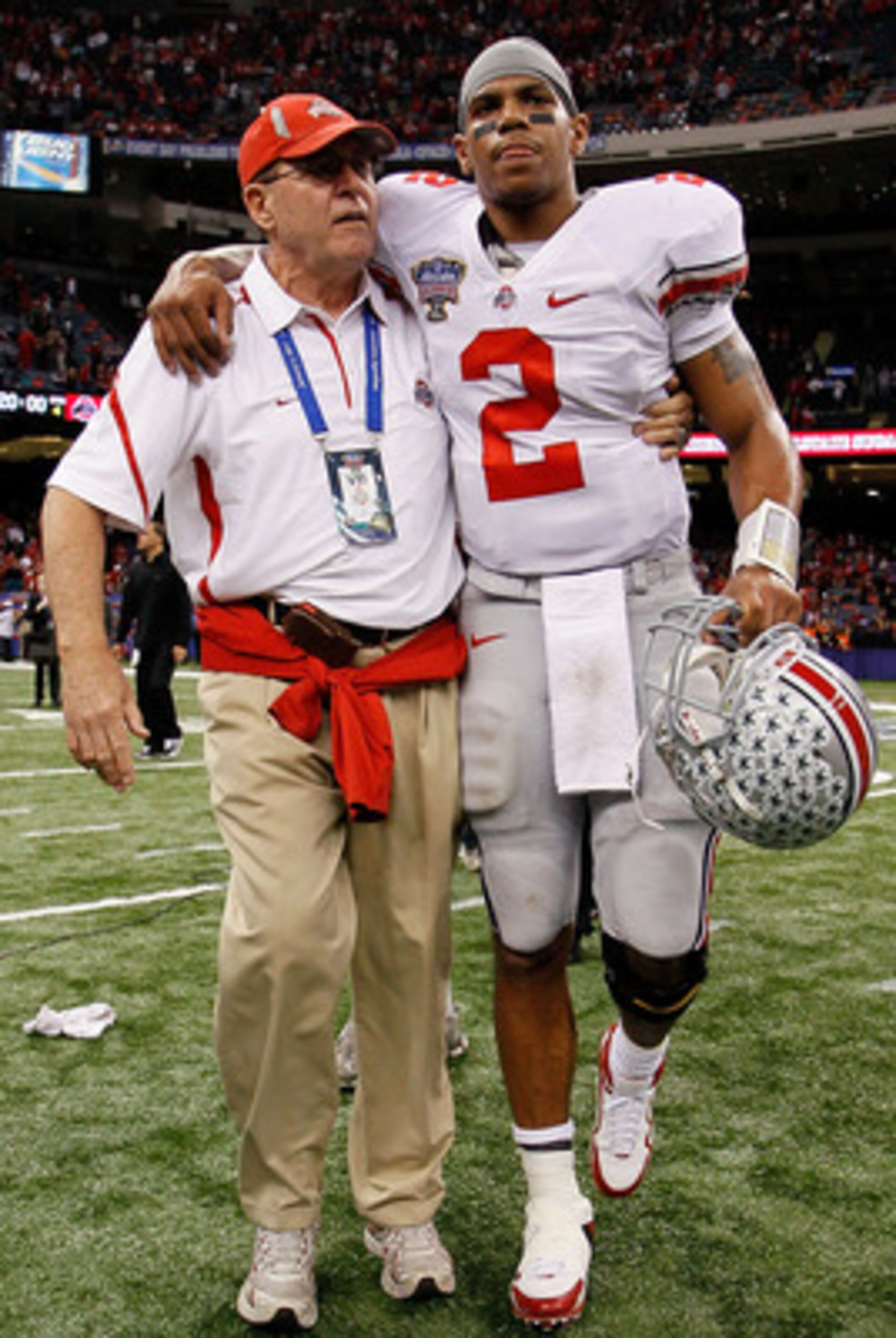 NEW ORLEANS, LA - JANUARY 04:  (M) Quarterback Terrelle Pryor #2 of the Ohio State Buckeyes is helped off the field by a member of the Buckeyes support team after the Buckeyes 31-26 victory against the Arkansas Razorbacks during the Allstate Sugar Bowl at