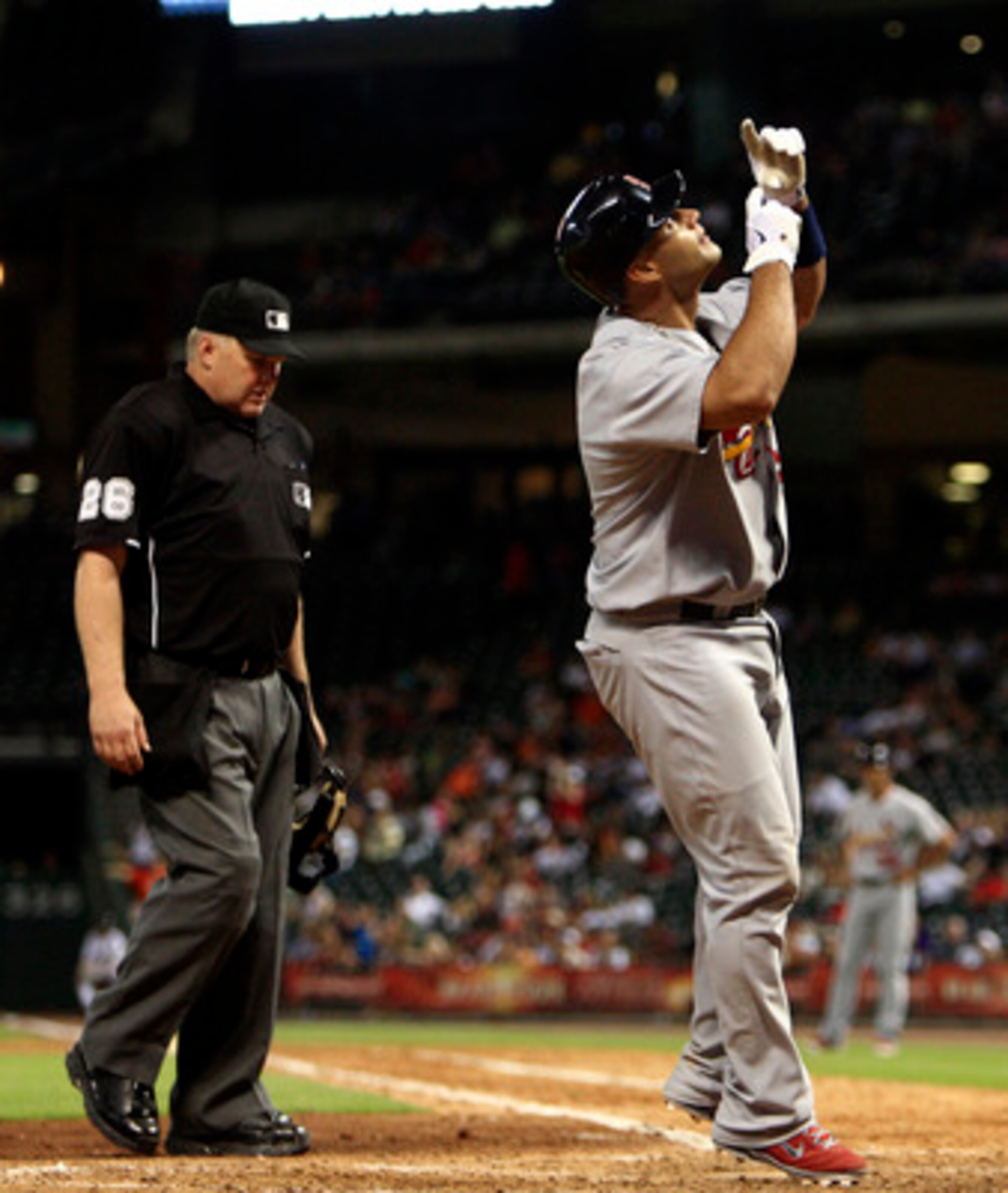 HOUSTON - JUNE 07:  Albert Pujols #5 of the St. Louis Cardinals celebrates at home plate after hitting a home run against the Houston Astros in the eighth inning at Minute Maid Park on June 7, 2011 in Houston, Texas.  (Photo by Bob Levey/Getty Images)