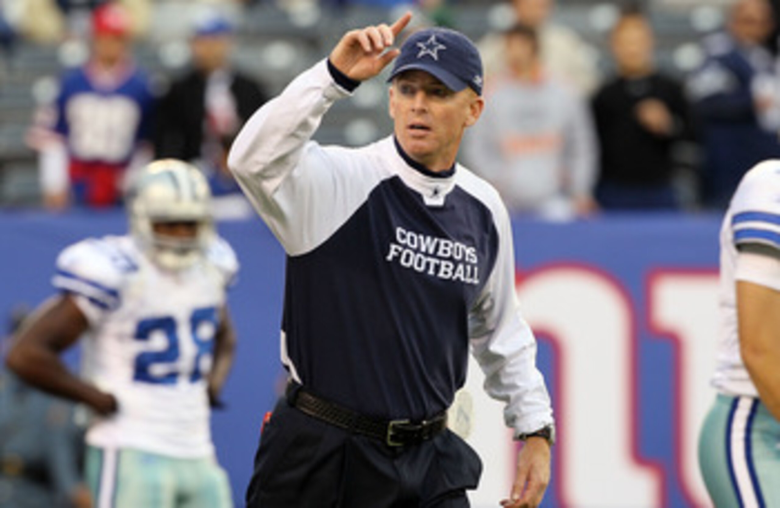 EAST RUTHERFORD, NJ - NOVEMBER 14:  Head coach Jason Garrett of the Dallas Cowboys works with his team as they warm up prior to playing against the New York Giants on November 14, 2010 at the New Meadowlands Stadium in East Rutherford, New Jersey.  (Photo