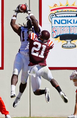 BLACKSBURG, VA - SEPTEMBER 18: Wide receiver Dwayne Harris #17 of the East Carolina Pirates catches a touchdown pass as cornerback Rashad Carmichael #21 of the Virginia Tech Hokies defends at Lane Stadium on September 18, 2010 in Blacksburg, Virginia. ( BLACKSBURG, VA - SEPTEMBER 18: Wide receiver Dwayne Harris #17 of the East Carolina Pirates catches a touchdown pass as cornerback Rashad Carmichael #21 of the Virginia Tech Hokies defends at Lane Stadium on September 18, 2010 in Blacksburg, Virginia. (