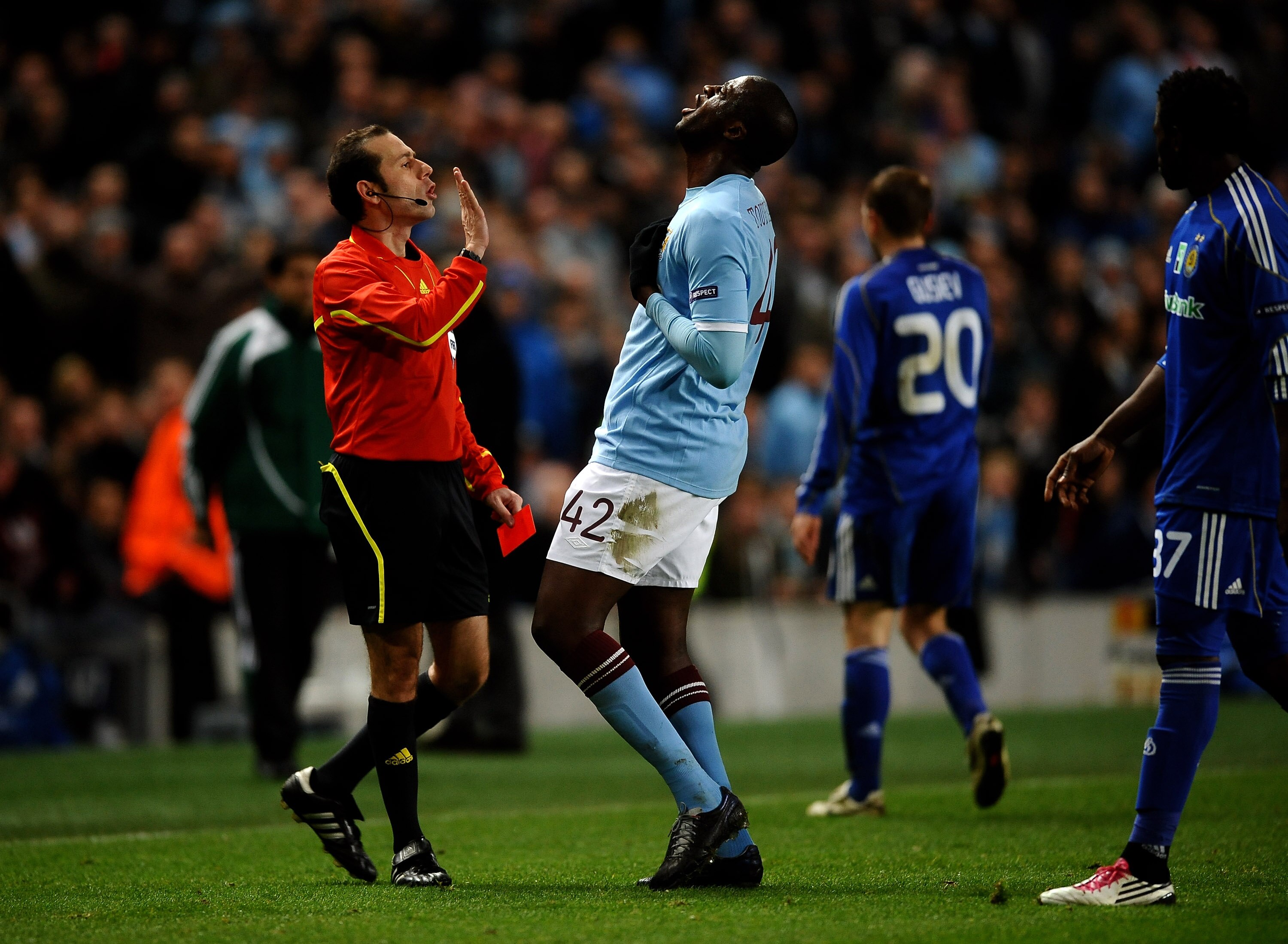 MANCHESTER, ENGLAND - MARCH 17:  Yaya Toure of Manchester City argues with referee Vladimir Sajn after he sent off Mario Balotelli of Manchester City during the UEFA Europa League round of 16 second leg match between Manchester City and Dynamo Kiev at Cit