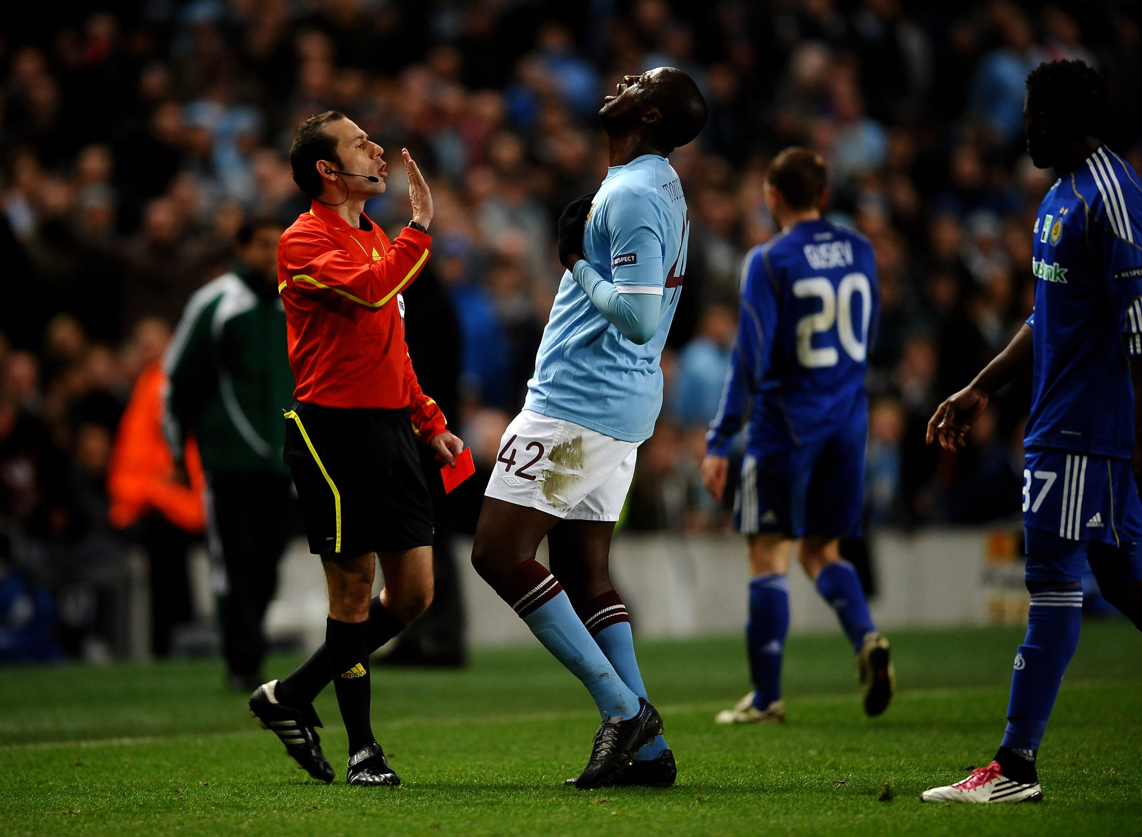 MANCHESTER, ENGLAND - MARCH 17: Yaya Toure of Manchester City argues with referee Vladimir Sajn after he sent off Mario Balotelli of Manchester City during the UEFA Europa League round of 16 second leg match between Manchester City and Dynamo Kiev at Cit MANCHESTER, ENGLAND - MARCH 17: Yaya Toure of Manchester City argues with referee Vladimir Sajn after he sent off Mario Balotelli of Manchester City during the UEFA Europa League round of 16 second leg match between Manchester City and Dynamo Kiev at Cit