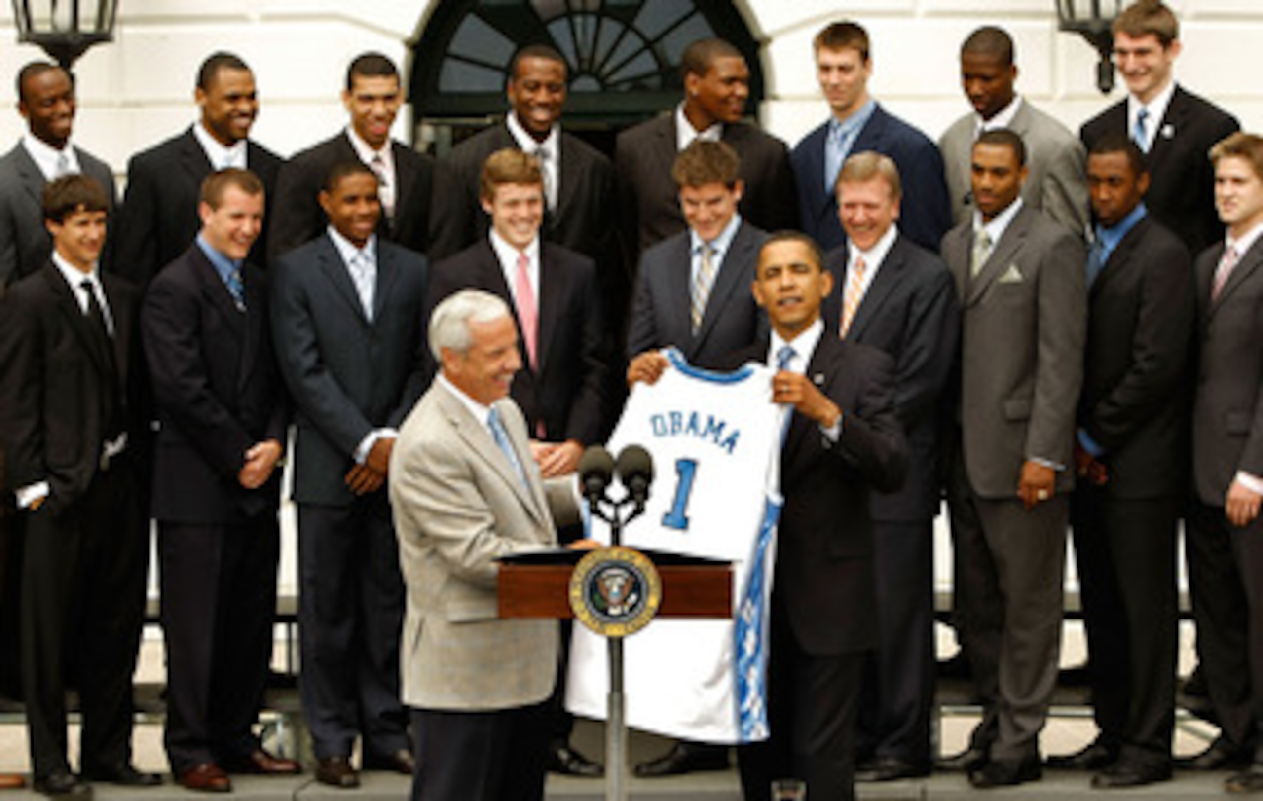 WASHINGTON - MAY 11:  University of North Carolina Men's basketball head coach Roy Williams (L) presents U.S. President Barack Obama with a team jersey at the White House May 11, 2009 in Washington, DC. The North Carolina Tar Heels are the 2009 National C