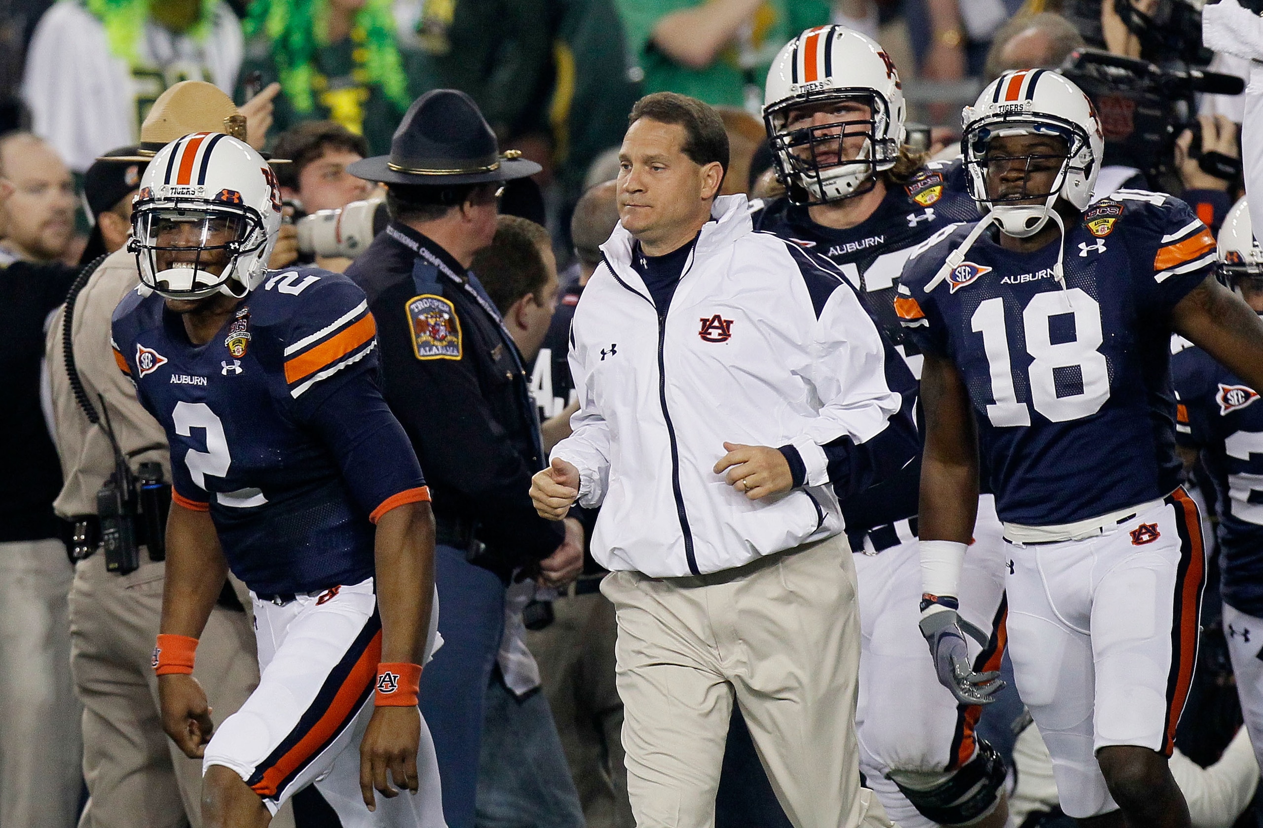 GLENDALE, AZ - JANUARY 10:  Cameron Newton #2, Head coach Gene Chizik, Lee Ziemba #73 and Kodi Burns #18 of the Auburn Tigers react on the sideline against the Oregon Ducks during the Tostitos BCS National Championship Game at University of Phoenix Stadiu