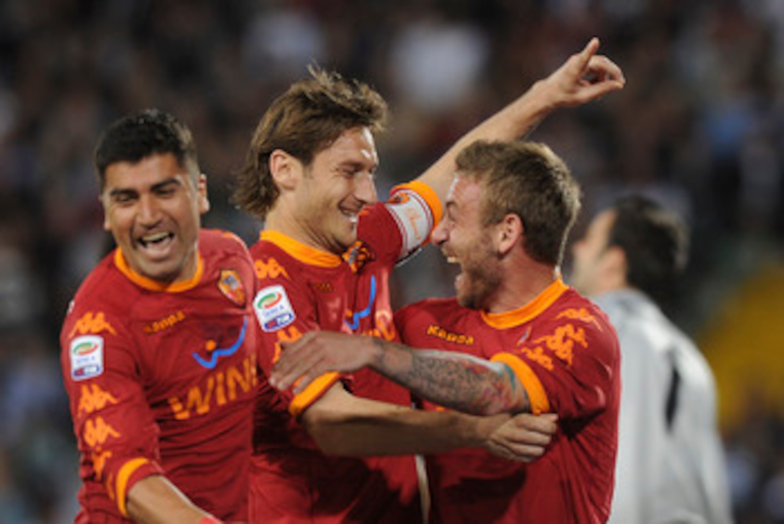 UDINE, ITALY - APRIL 09: Francesco Totti (C) of Roma celebrates with teams mates Daniele De Rossi and David Pizarro after scoring his opening penalty goal during the Serie A match between Udinese Calcio and AS Roma at Stadio Friuli on April 9, 2011 in UDINE, ITALY - APRIL 09: Francesco Totti (C) of Roma celebrates with teams mates Daniele De Rossi and David Pizarro after scoring his opening penalty goal during the Serie A match between Udinese Calcio and AS Roma at Stadio Friuli on April 9, 2011 in