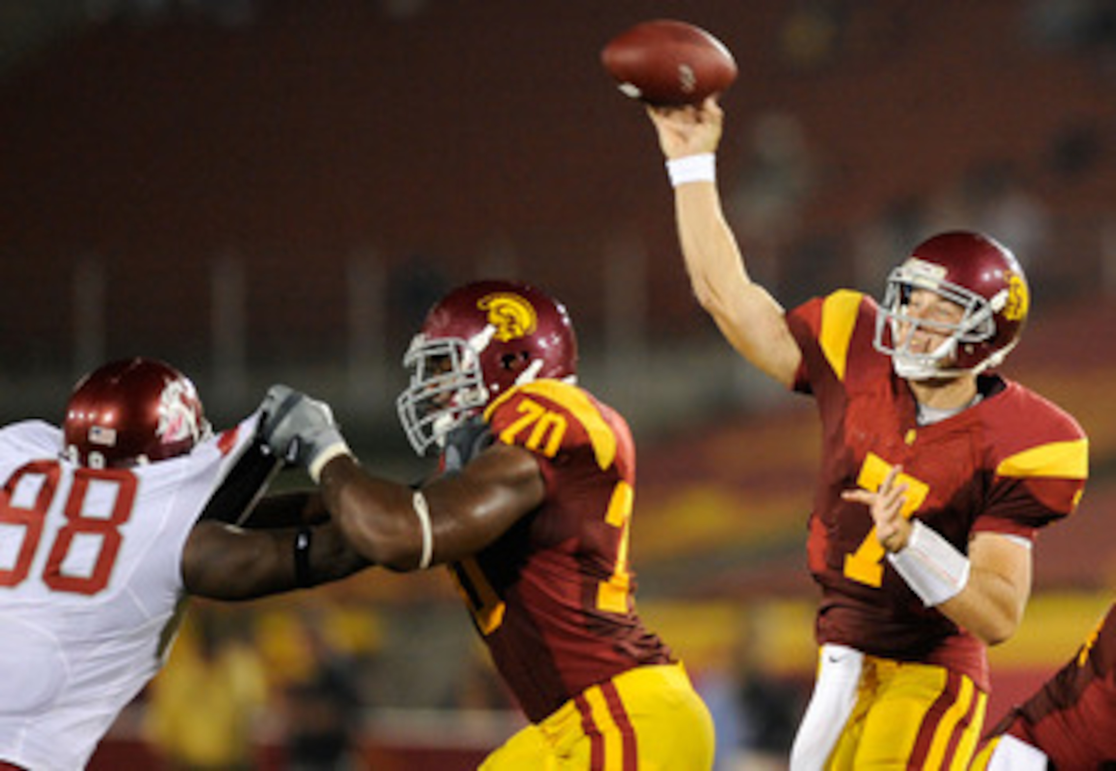 LOS ANGELES, CA - SEPTEMBER 26:   Quarterback Matt Barkley #7 of the USC Trojans throws a pass as Tyron Smith #70 blocks Jesse Feagin #98 of  the Washington State Cougars during the second quarter of the college football game at the Los Angeles Memorial C