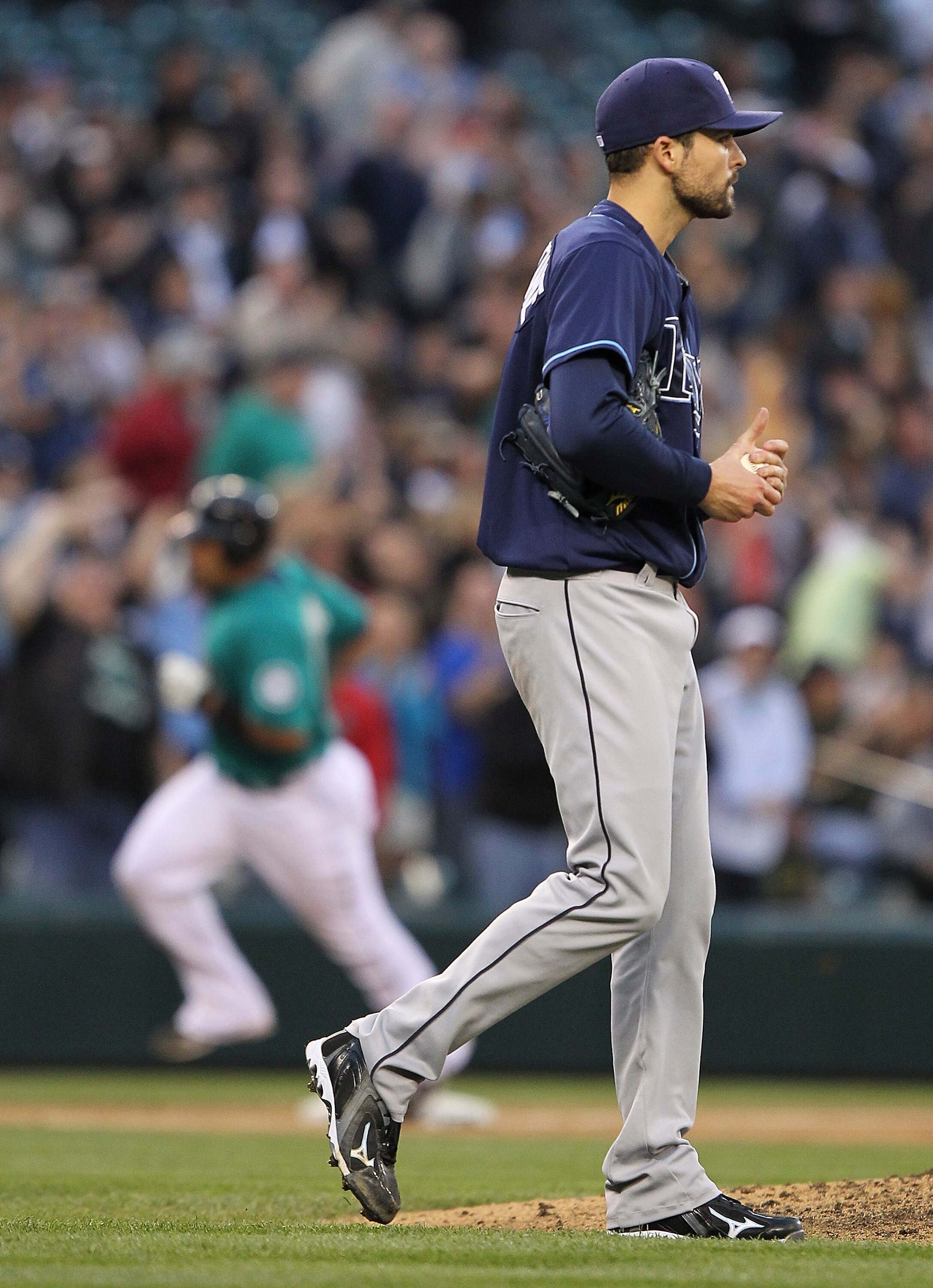 SEATTLE - JUNE 03:  Miguel Olivo #30 of the Seattle Mariners rounds third base after hitting a home run off of starting pitcher Andy Sonnanstine #21 (foreground) of the Tampa Bay Rays at Safeco Field on June 3, 2011 in Seattle, Washington. (Photo by Otto