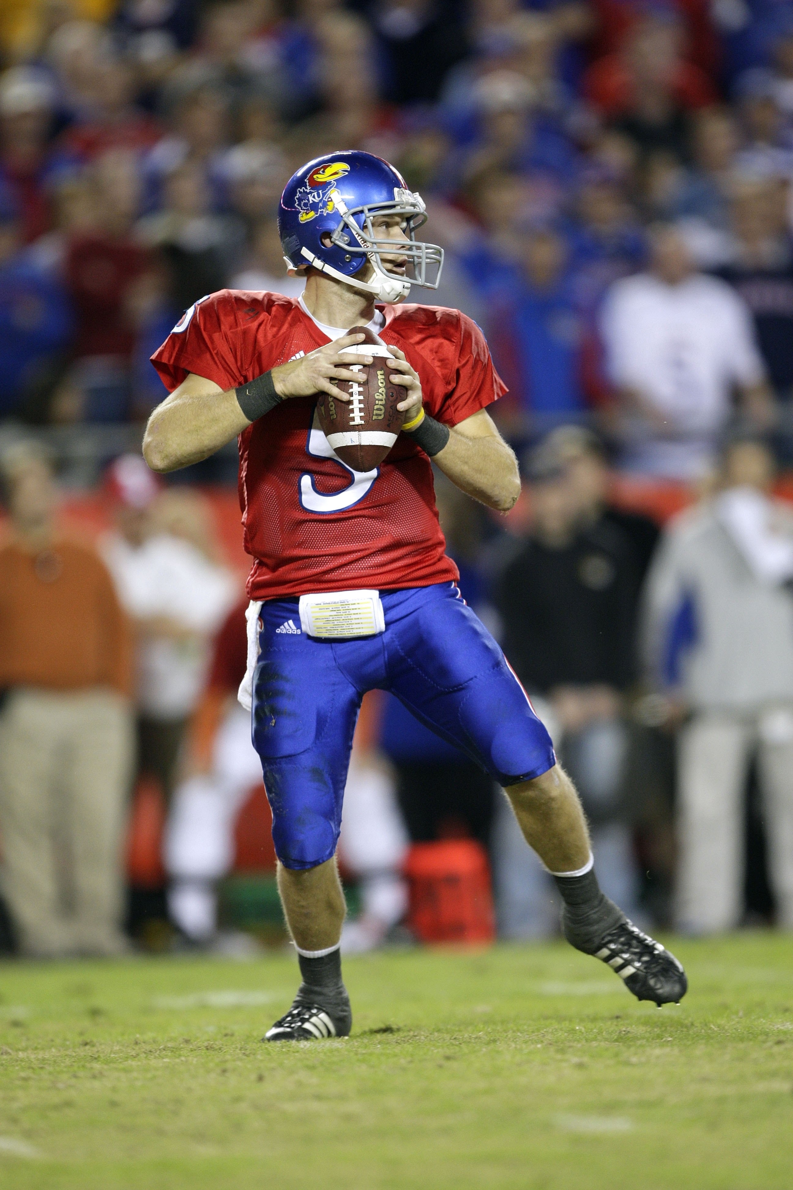 KANSAS CITY, MO - NOVEMBER 28: Quarterback Todd Reesing #5 of the Kansas Jayhawks looks to make a pass play during the game against the Missouri Tigers at Arrowhead Stadium on November 28, 2009 in Kansas City, Missouri. (Photo by Jamie Squire/Getty Images