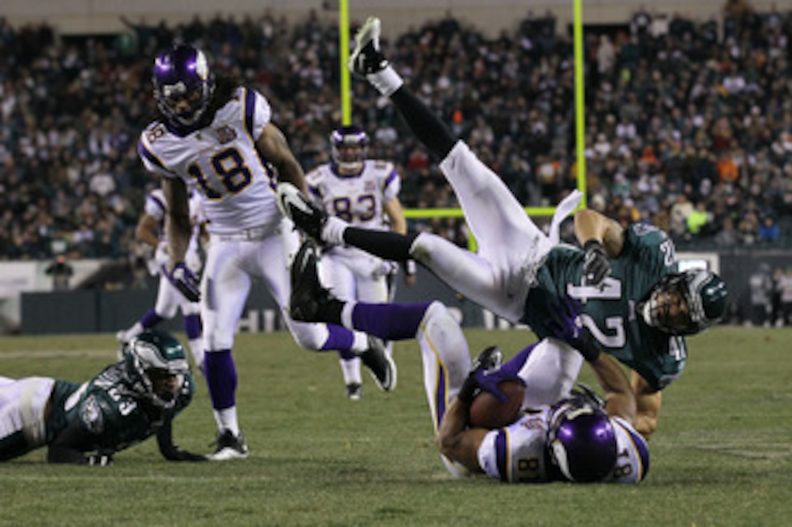 PHILADELPHIA, PA - DECEMBER 28:  Kurt Coleman #42 of the Philadelphia Eagles tackles Visanthe Shiancoe #81 of the Minnesota Vikings at Lincoln Financial Field on December 26, 2010 in Philadelphia, Pennsylvania.  (Photo by Jim McIsaac/Getty Images)