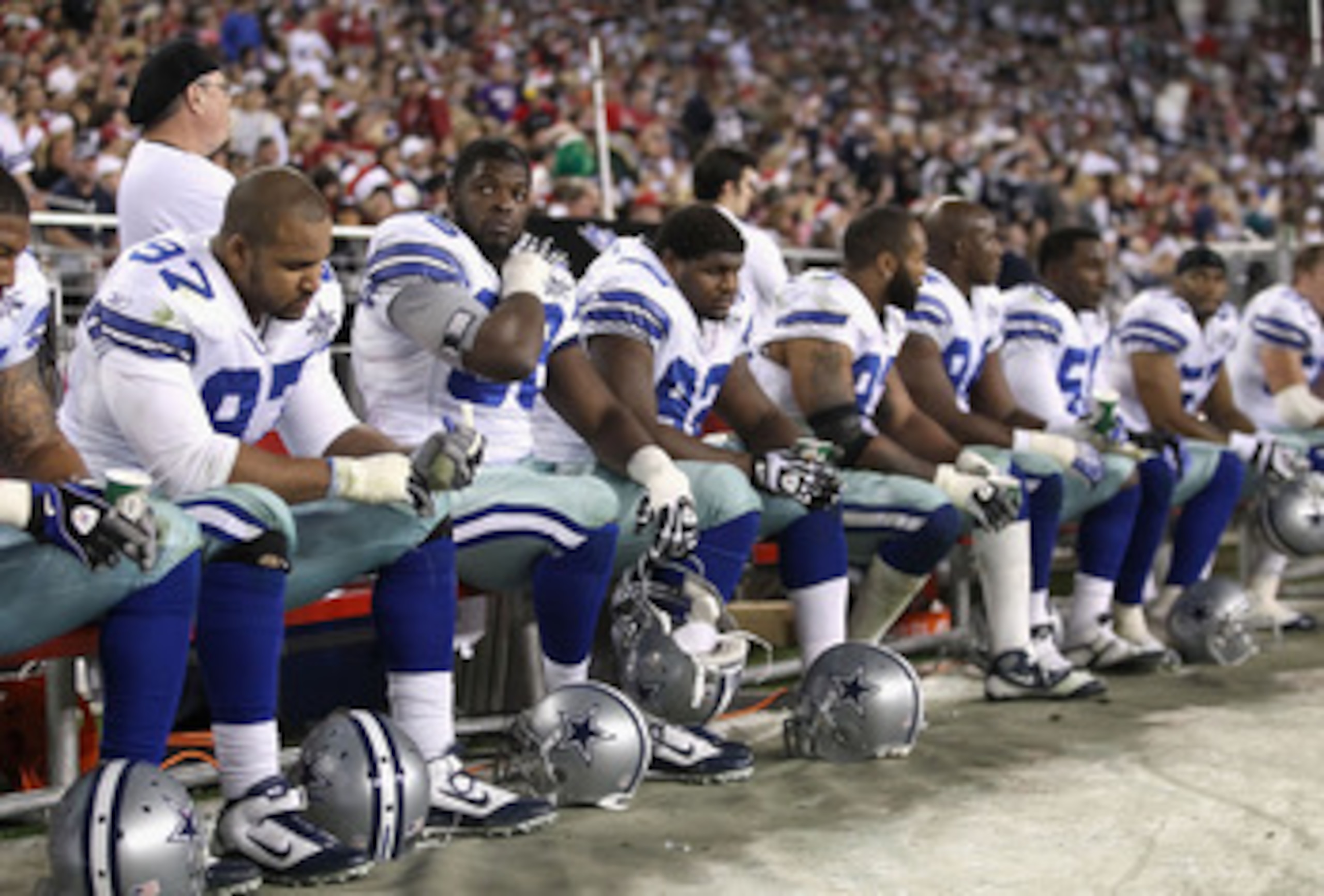 GLENDALE, AZ - DECEMBER 25:  (2nd from left) Clifton Geathers #66 of the Dallas Cowboys looks up from the bench during the NFL game against the Arizona Cardinals at the University of Phoenix Stadium on December 25, 2010 in Glendale, Arizona. The Cardinals