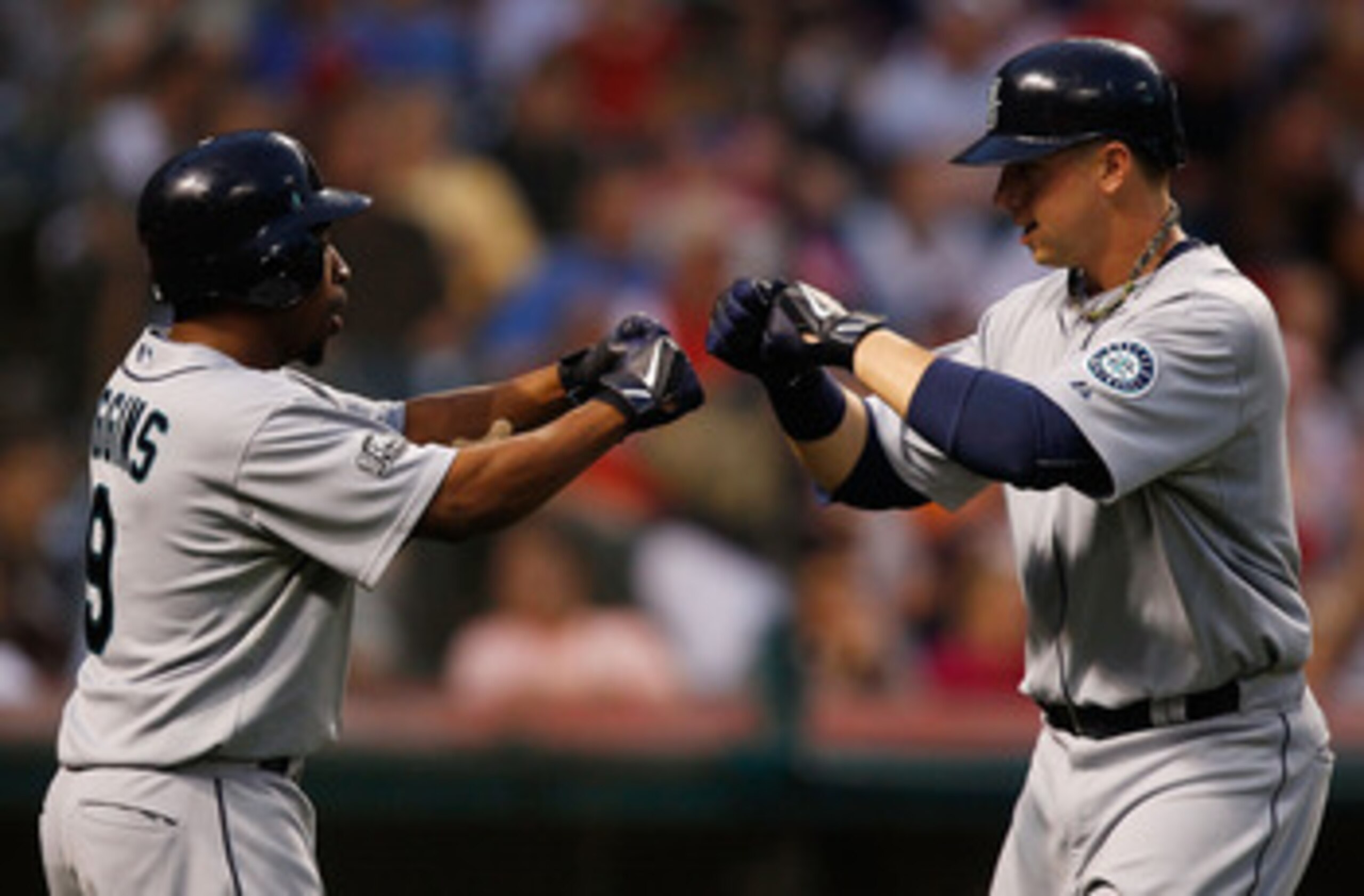 CLEVELAND - MAY 13: Justin Smoak #17 of the Seattle Mariners celebrates with teammate Chone Figgins #9 after hitting a two run home run against the Cleveland Indians during the game on May 13, 2011 at Progressive Field in Cleveland, Ohio. (Photo by Jared CLEVELAND - MAY 13: Justin Smoak #17 of the Seattle Mariners celebrates with teammate Chone Figgins #9 after hitting a two run home run against the Cleveland Indians during the game on May 13, 2011 at Progressive Field in Cleveland, Ohio. (Photo by Jared