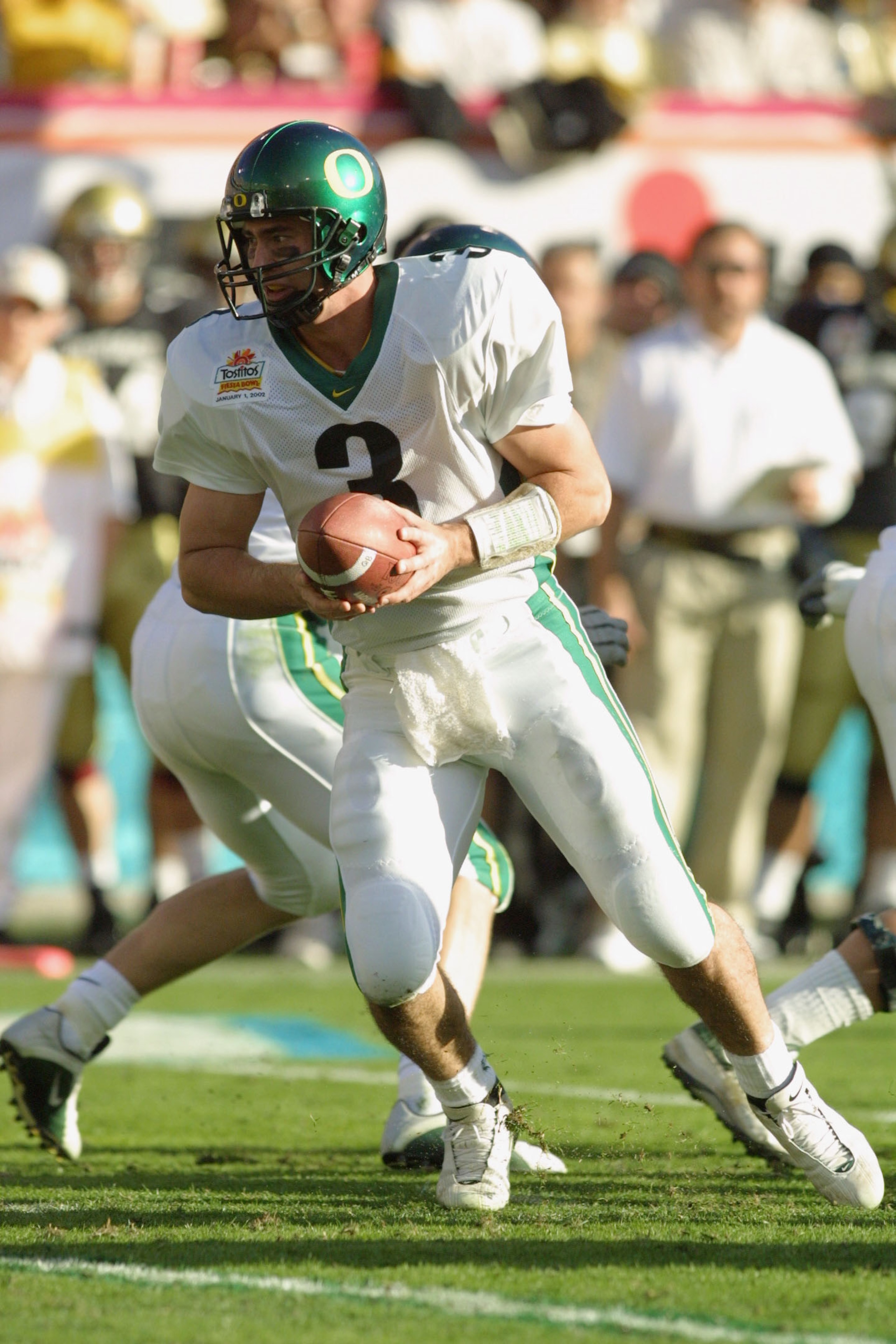01 Jan 2002 : Quarterback Joey Harrington of Oregon looks for an opening against Colorado during the game at the Fiesta Bowl at Sun Devil Stadium in Tempe, Arizona. The Oregon Ducks won 38-16. DIGITAL IMAGE. Mandatory Credit: Jeff Gross/Getty Images 01 Jan 2002 : Quarterback Joey Harrington of Oregon looks for an opening against Colorado during the game at the Fiesta Bowl at Sun Devil Stadium in Tempe, Arizona. The Oregon Ducks won 38-16. DIGITAL IMAGE. Mandatory Credit: Jeff Gross/Getty Images