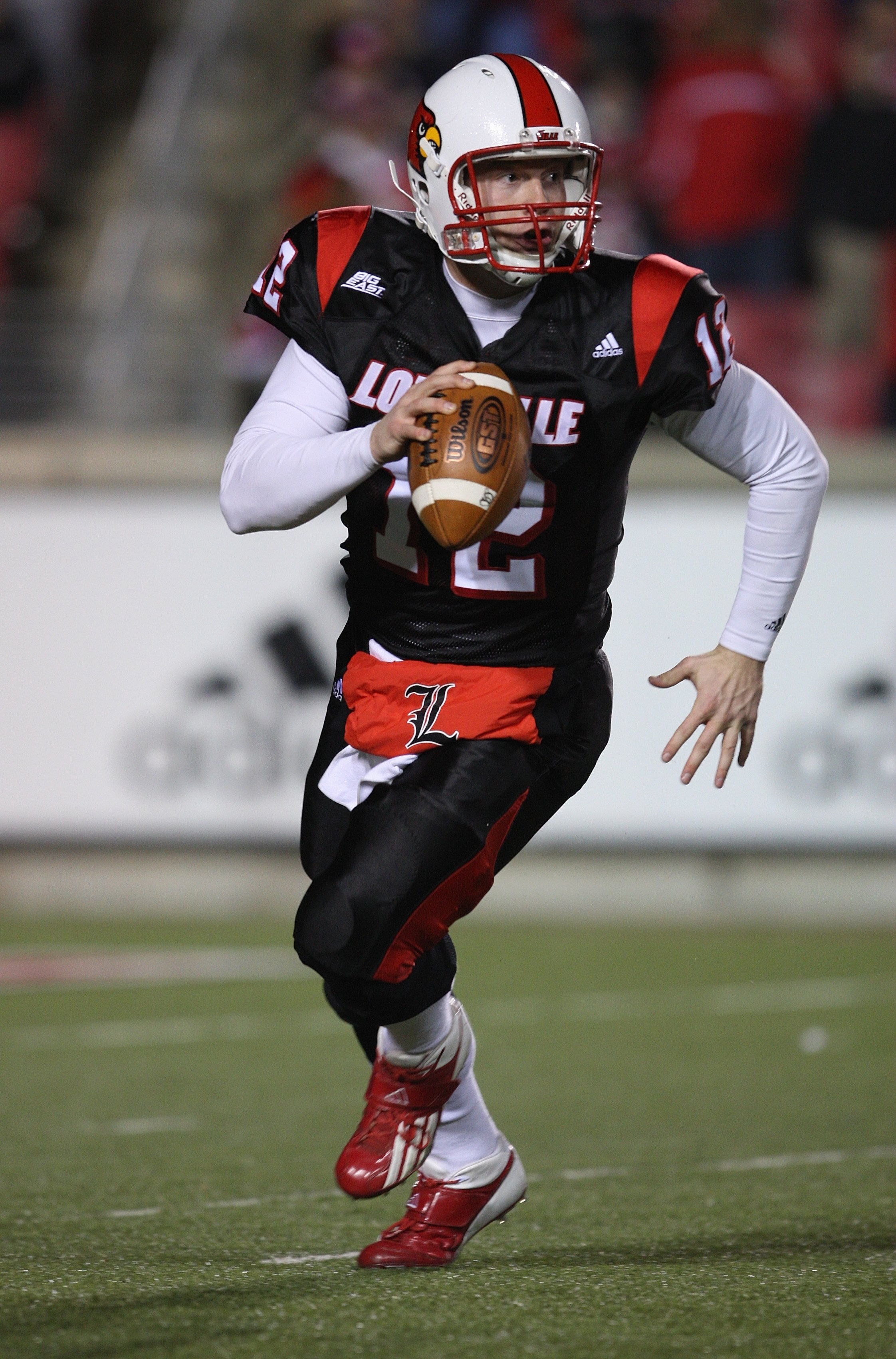 LOUISVILLE, KY - NOVEMBER 29:  Brian Brohm #12 of the Louisville Cardinals rolls out to pass during the Big East Conference game against the Rutgers Scarlet Knights on November 29, 2007 at Papa John's Stadium. (Photo by Andy Lyons/Getty Images)