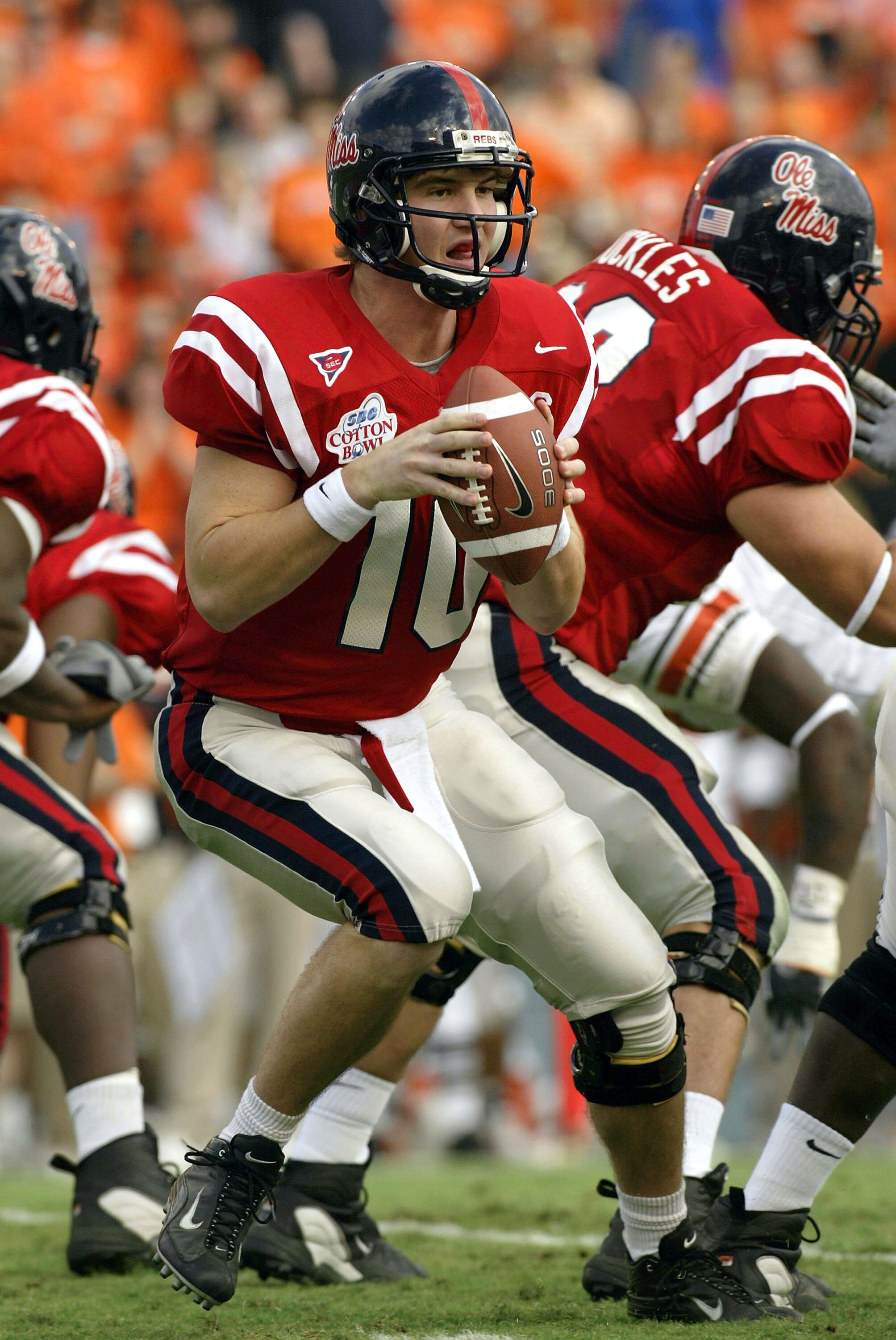 DALLAS - JANUARY 2:  Eli Manning #10 of the Mississippi Rebels drops back to pass against the Oklahoma State Cowboys during the SBC Cotton Bowl on January 2, 2004 in Dallas, Texas.  The Ole Miss Rebels defeated the Cowboys 31-28.  (Photo by Ronald Martine