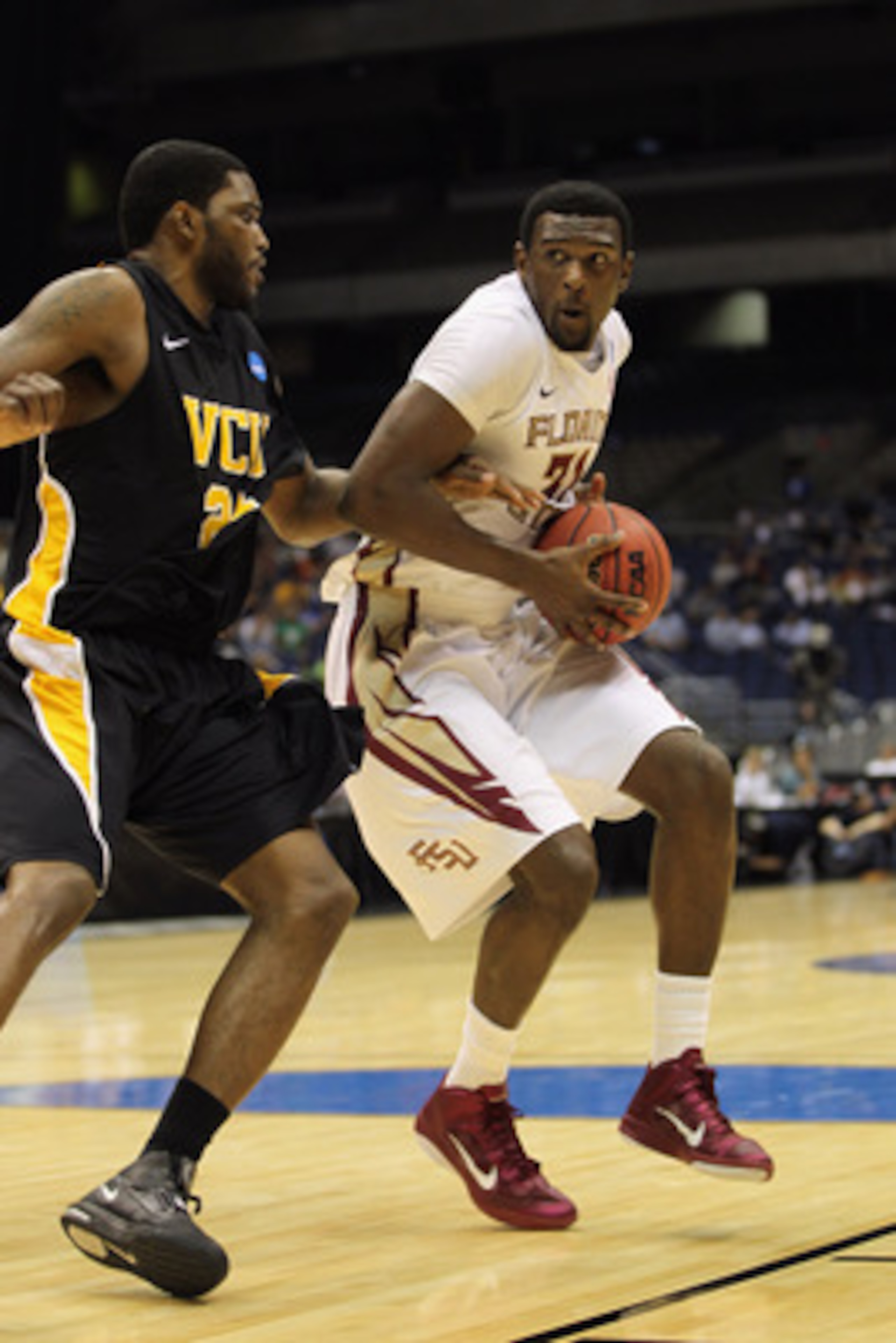 SAN ANTONIO, TX - MARCH 25:  Chris Singleton #31 of the Florida State Seminoles handles the ball against Jamie Skeen #21 of the Virginia Commonwealth Rams during the southwest regional of the 2011 NCAA men's basketball tournament at the Alamodome on March