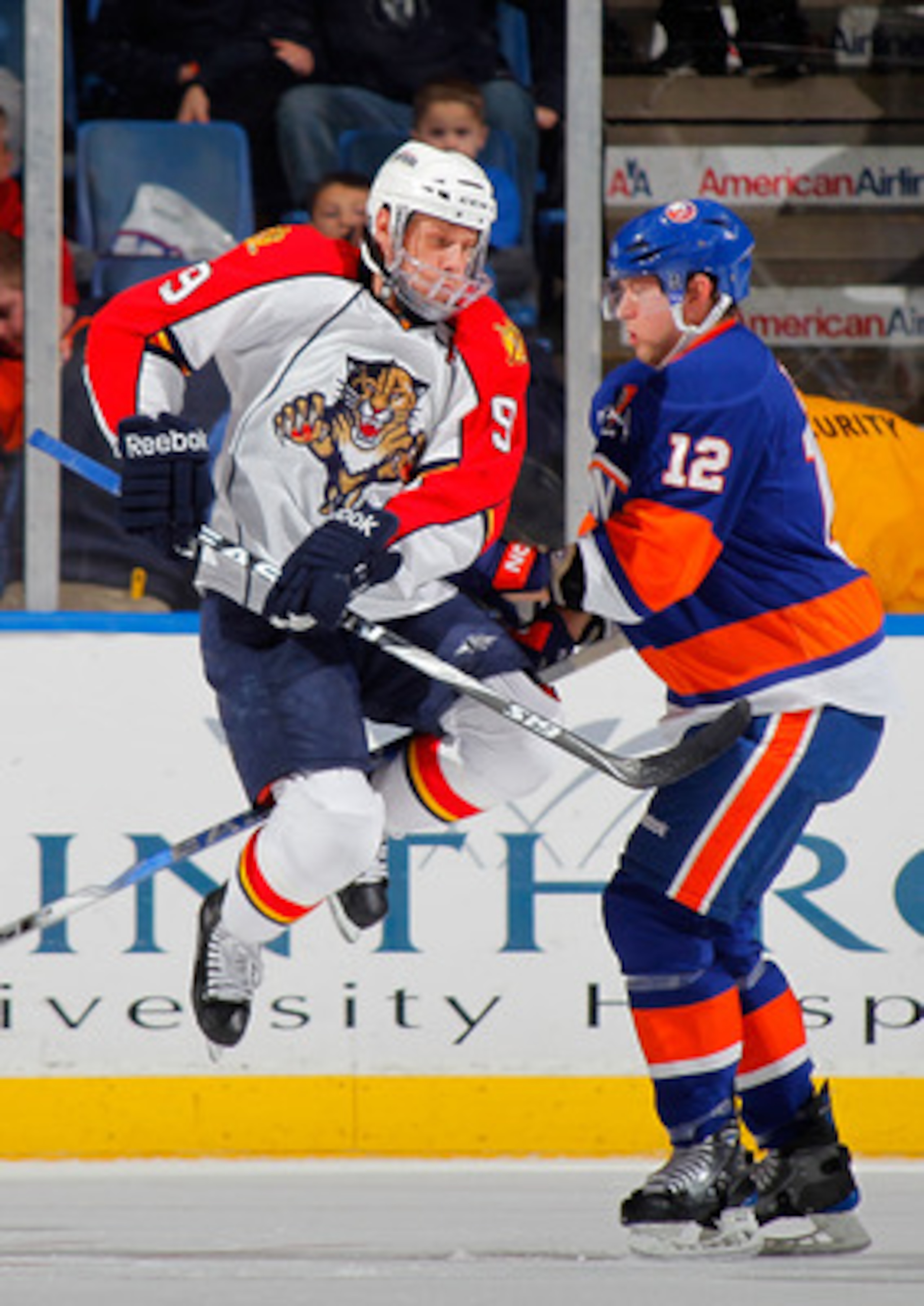 UNIONDALE, NY - NOVEMBER 20: Stephen Weiss #9 of the Florida Panthers tries to leap out of the way of a slapshot from the point as Josh Bailey #12 of the New York Islanders defends during the second period of a hockey game at the Nassau Coliseum on Novem UNIONDALE, NY - NOVEMBER 20: Stephen Weiss #9 of the Florida Panthers tries to leap out of the way of a slapshot from the point as Josh Bailey #12 of the New York Islanders defends during the second period of a hockey game at the Nassau Coliseum on Novem