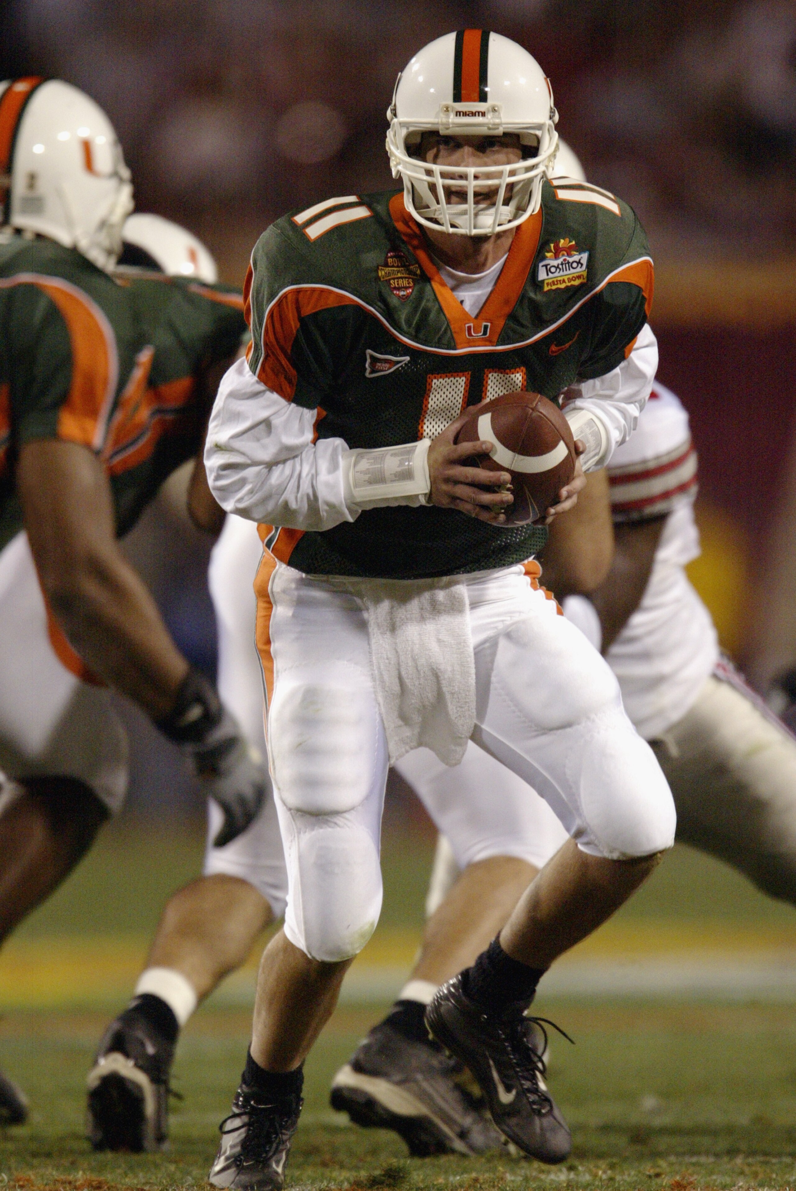 TEMPE, ARIZONA - JANUARY 3: Quarterback Ken Dorsey #11 of the University of Miami Hurricanes prepares to hand off the ball against the Ohio State Buckeyes in the Tostitos Fiesta Bowl at Sun Devil Stadium on January 3, 2003 in Tempe, Arizona. Ohio State TEMPE, ARIZONA - JANUARY 3: Quarterback Ken Dorsey #11 of the University of Miami Hurricanes prepares to hand off the ball against the Ohio State Buckeyes in the Tostitos Fiesta Bowl at Sun Devil Stadium on January 3, 2003 in Tempe, Arizona. Ohio State