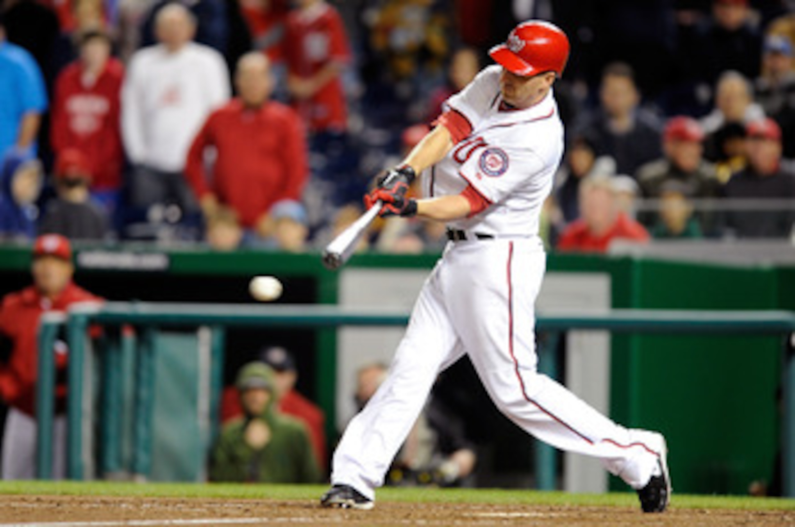 WASHINGTON, DC - APRIL 15: Adam LaRoche #25 of the Washington Nationals drives in the winning run in the tenth inning against the Milwaukee Brewers at Nationals Park on April 15, 2011 in Washington, DC. The Nationals won the game 4-3. All players, coache WASHINGTON, DC - APRIL 15: Adam LaRoche #25 of the Washington Nationals drives in the winning run in the tenth inning against the Milwaukee Brewers at Nationals Park on April 15, 2011 in Washington, DC. The Nationals won the game 4-3. All players, coache