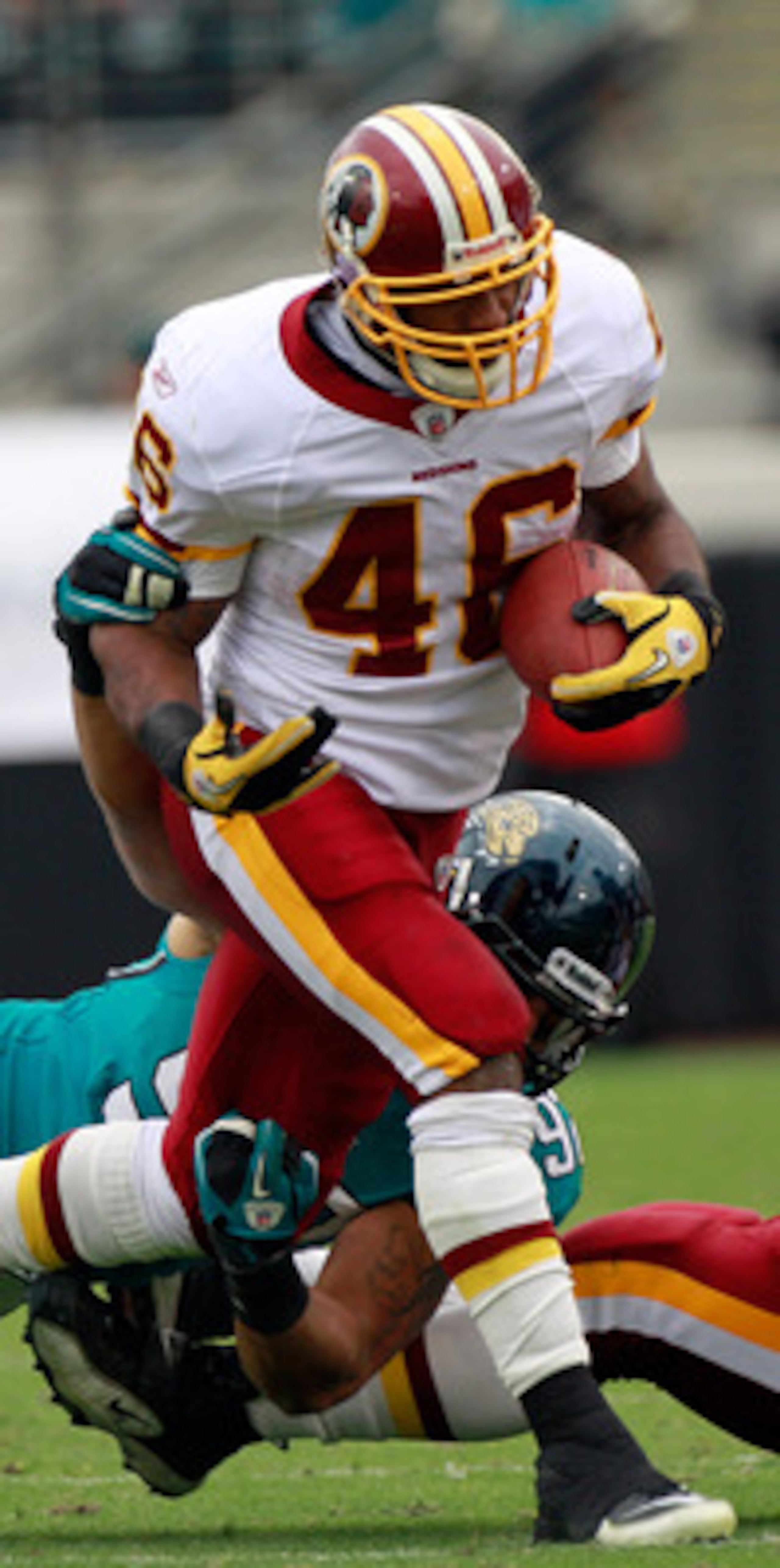 JACKSONVILLE, FL - DECEMBER 26: Austen Lane #92 of the Jacksonville Jaguars attempts to tackle Ryan Torain #46 of the Washington Redskins during the game at EverBank Field on December 26, 2010 in Jacksonville, Florida.  (Photo by Sam Greenwood/Getty Image