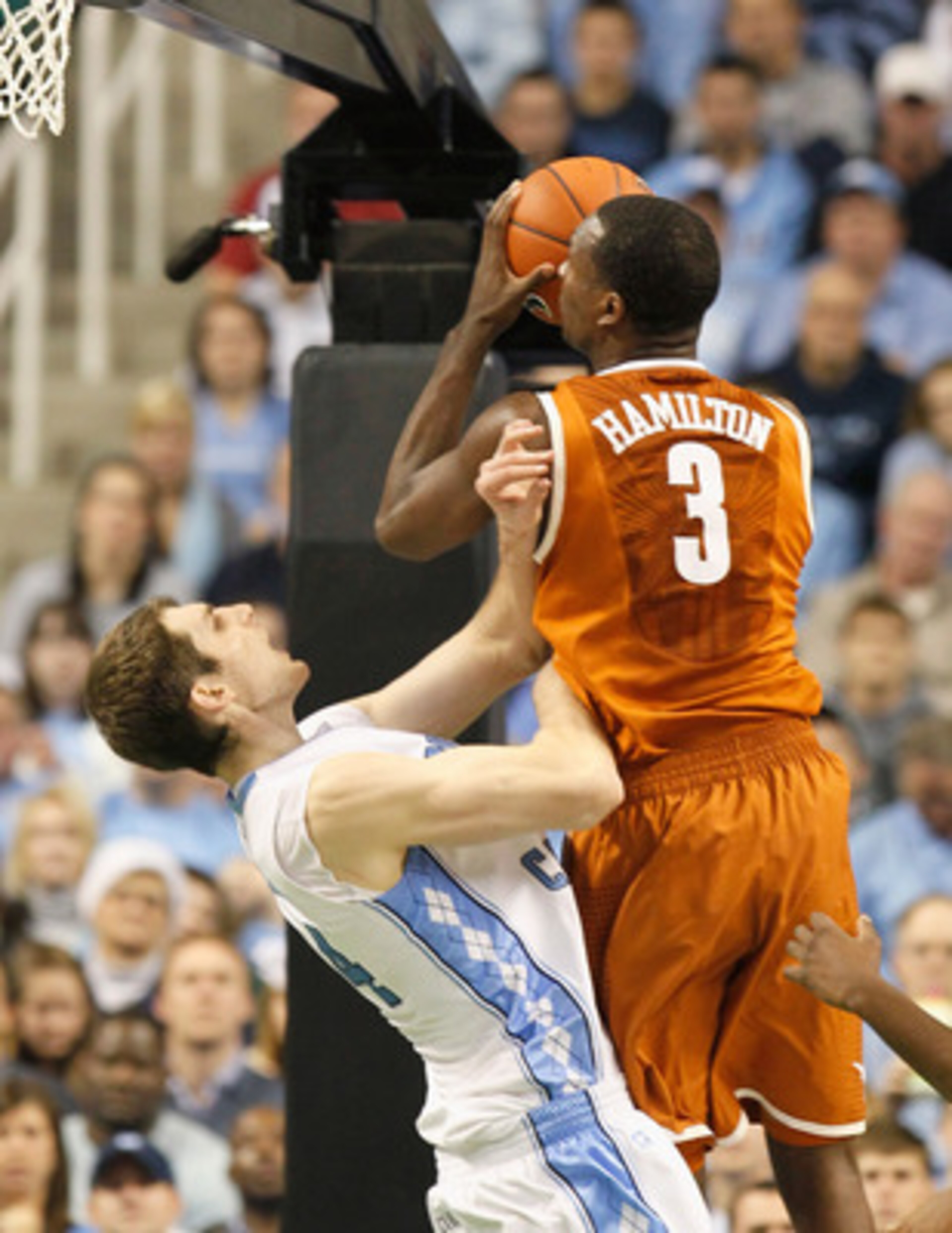 GREENSBORO, NC - DECEMBER 18:  Tyler Zeller #44 of the North Carolina Tar Heels takes a charge from Jordan Hamilton #3 of the Texas Longhorns at Greensboro Coliseum on December 18, 2010 in Greensboro, North Carolina.  (Photo by Kevin C. Cox/Getty Images)
