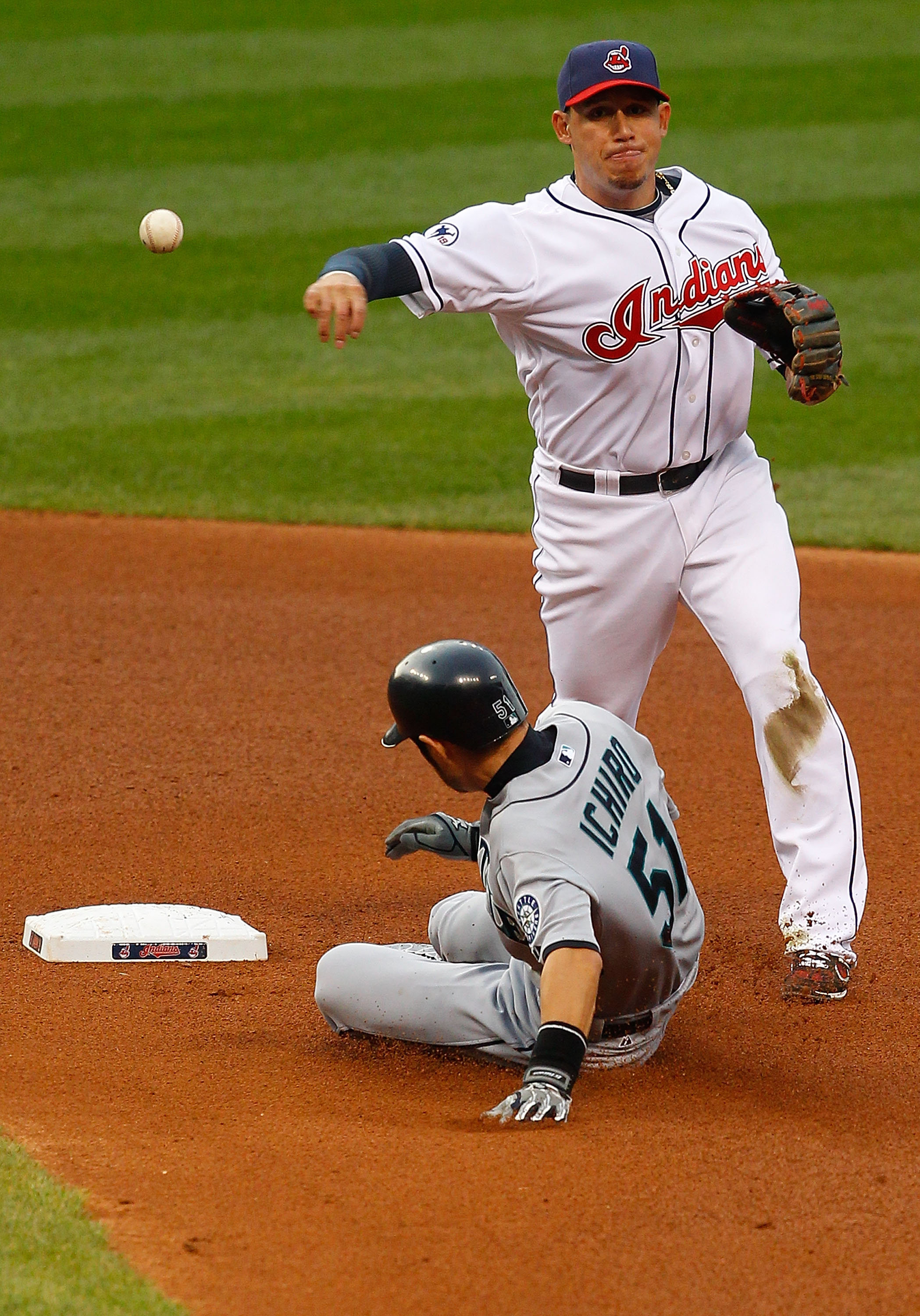 CLEVELAND - MAY 13:  Asdrubal Cabrera #13 of the Cleveland Indians attempts to turn the double play on Ichiro Suzuki #51 of the Seattle Mariners during the game on May 13, 2011 at Progressive Field in Cleveland, Ohio.  (Photo by Jared Wickerham/Getty Imag