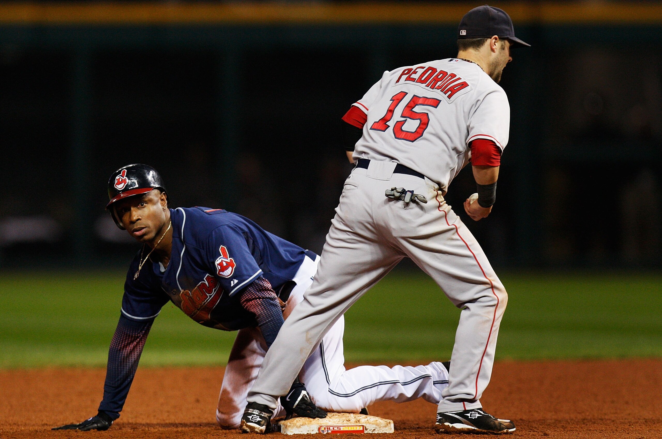CLEVELAND - OCTOBER 16:  Kenny Lofton #7 of the Cleveland Indians looks on after stealing a base in the fifth inning against Dustin Pedroia #15 of the Boston Red Sox during Game Four of the American League Championship Series at Jacobs Field on October 16